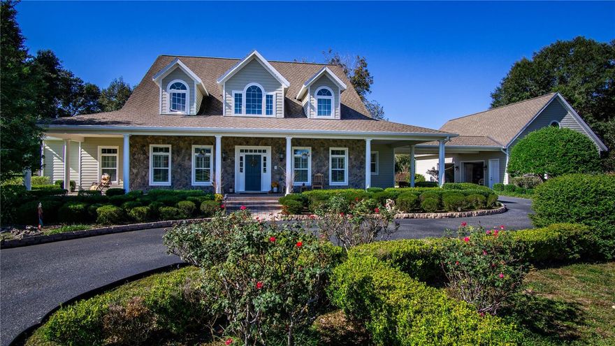 Welcome to this stunning 5-bedroom, 6-bathroom, 4,871 SF custom American Farmhouse on 10.5 acres in the gated community of Equine Estates. Built by Mega Construction in 2006, this exceptional home is crafted for those who value fine craftsmanship, privacy, and an equestrian lifestyle. Enjoy direct access to the 110-mile Marjorie Harris Carr Cross Florida Greenway—ride straight from your property to the Florida Horse Park, or explore three miles of private community bridle paths beneath majestic granddaddy oaks.

Main Residence: 

Showcasing timeless design and top of the line materials with all original receipts. The exterior features Hardie board siding, stone veneer accents, a steep gable roof, dormer windows and a large welcoming Brazilian hardwood porch with columns. Step into the two-story coral stone foyer, where a custom red oak staircase and balcony rail set an elegant tone carried throughout the home.

The great room impresses with a cathedral beamed tray ceiling and an architectural stone floor-to-ceiling handcrafted fireplace  complemented by a towering custom red oak entertainment center that echoes the home’s stunning staircase and flooring. 

The gourmet kitchen is a chef’s dream—granite countertops, shaker cabinetry, coral stone floors, pendant lighting, dual pantries, and island seating. A laundry room off the kitchen continues the fine craftsmanship with matching shaker cabinetry and coral stone flooring. The   kitchen has an eat-in area, plus an additional formal dining or secondary kitchen space off the great room—

The primary suite is a true retreat with red oak flooring, plantation shutters, a serene sitting retreat overlooking the pool and pastures and a spa-inspired bath featuring coral stone floors, dual stone vanities, a soaking tub encased in stone, and a glass shower with coral stone flooring.

Upstairs, three spacious ensuite bedrooms feature Kohler fixtures, Corian vanities, and frameless glass showers, while an additional 810-square-foot finished space above the three-car garage with a private entrance and half bath providing a perfect gym, office, or guest suite.

Outdoor Living:

Step through the French doors to a vaulted, screened lanai wrapped in rich Brazilian hardwood decking, where a warm oak ceiling and a floor-to-ceiling stone fireplace—designed for both gas and wood burning—create the perfect backdrop for every season. The lanai offers a picturesque vantage point overlooking the saltwater pool, horse barn, and sunlit pastures.

Equestrian Barn:

The 2,548-square-foot center isle block barn is designed for function and comfort, featuring four stalls, an Air conditioned tack and feed room, two hot/cold wash racks, a shoo fly system and a dedicated equipment room featuring workbenches and shelving along with a climate-controlled office with half bath providing convenience and comfort.

The property’s lush 10.5-acre pastures are fully fenced and cross fenced, offering an ideal setup for horses and cattle.

Modern Systems & Features:

5-unit multi-zone HVAC (2 new 2025; 4 home + 1 barn office)-

Whole-house Generac generator (July 2025 service)-

Dual propane tanks-

Updated water heaters, bladder tank (2024), irrigation (2025 panel)-

NuTone central vac, 10-year termite bond (to 2035)-

Porte-cochère with 30-amp RV hookup for vehicles or guest use.