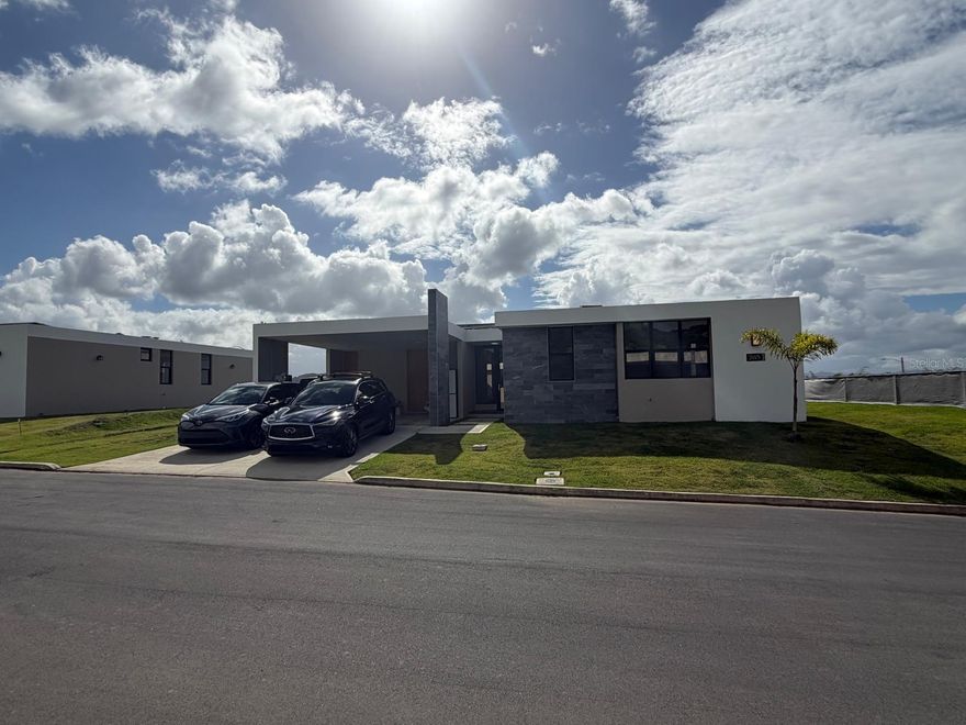 Corner Lot, Danubio model home featuring 4 bedrooms and 3.5 bathrooms, located in one of the few sections of the community offering scenic views.

Property features include a transferable lease of solar system with 20 panels and one battery, microwave, electric cooktop, oven, refrigerator, washer, dryer, two inverter A/C units, Whirlpool jacuzzi, and five ceiling fans.

Located in a quiet, gated community with controlled access, requiring passage through two security checkpoints prior to reaching the residence.

Community amenities include tennis courts, basketball court, pickleball courts, beach tennis courts, restaurants, and spa.

Conveniently located with easy access to main roads, approximately 4.6 miles to hospitals, 8.5 miles to shopping centers, and 21 miles to Luis Muñoz Marín International Airport.