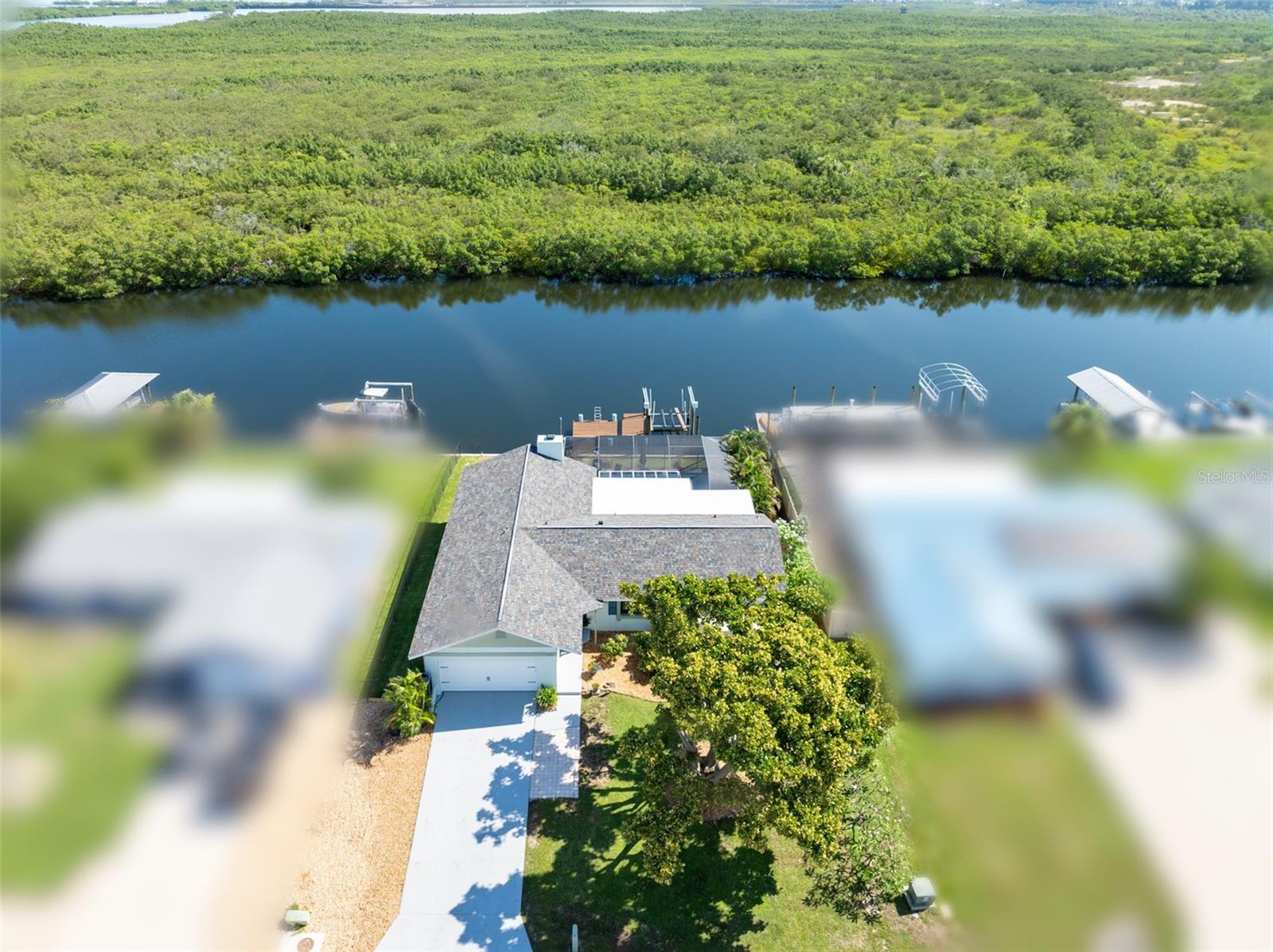 Rare Waterfront Opportunity with No Backyard Neighbors—Just Florida Wildlife! This custom built home offers the perfect blend of privacy, nature, and boating access. Situated on a deep-water canal with direct access to Tampa Bay, it's ideal for larger vessels and water enthusiasts alike. With NO HOA or CDD and situated at a higher elevation that has NEVER flooded, you'll enjoy both freedom and peace of mind. This home features an open layout with modern finishes, offering 3 bedrooms, 2.5 bathrooms, an office, family room, and a living room with a cozy rock fireplace. The standout feature is the expansive Florida room—perfect for year-round relaxation while enjoying panoramic water views and watching dolphins and manatees swim by-an experience that truly never gets old. Outside is just as great with a large screened patio and heated pool that has built-in benches—perfect for relaxing while taking in waterfront views. Whether you're entertaining or just enjoying a quiet moment, this outdoor space is made for it. Recent upgrades include the following. Roof (2018), HVAC with UV Sterilizer (2023),Mini Split AC for Florida Room (2021), Hot Water Heater (2024), Electric Panel (2018), Pool Pump (2024), Insulated Garage Door (2025), Polyaspartic Garage Flooring (2025), Kitchen Reverse Osmosis System, Water Softener, Tongue and Groove Ceilings, Double-Pane Windows, 10,000 lb Boat Lift, assumable flood insurance $1,214/year. If you’re looking for a waterfront home with space, privacy, and majority of the work already done, this is the one. Enjoy something special that very few waterfront properties have-deep water, unrestricted Bay access, and NO BACKYARD NEIGHBORS.