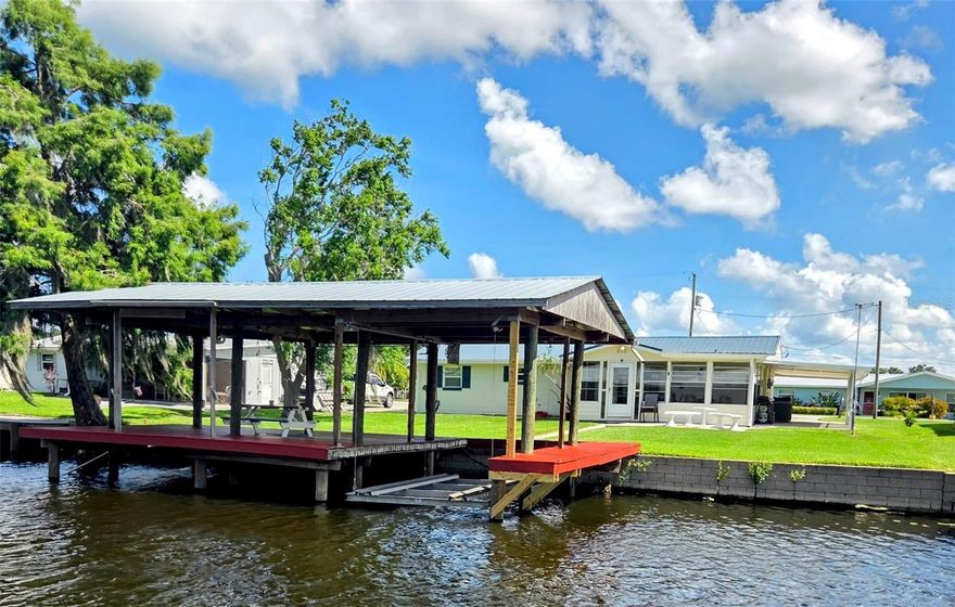 Freshly painted, this cute 2 bedroom 1.5 bath concrete block home is a fabulous winter retreat from the cold, or weekend getaway for boating and fisherman!! It has a wonderful dock for outside gatherings and boathouse. The enclosed back porch overlooking the water is also a great spot to entertain! Whether it is a weekend retreat or full-time residence, this is a great place to live! There is an attached garage, two driveways, and a nice carport. Fish from home!! Astor has great fishing and boating, and is close to all that Central Florida is famous for!!