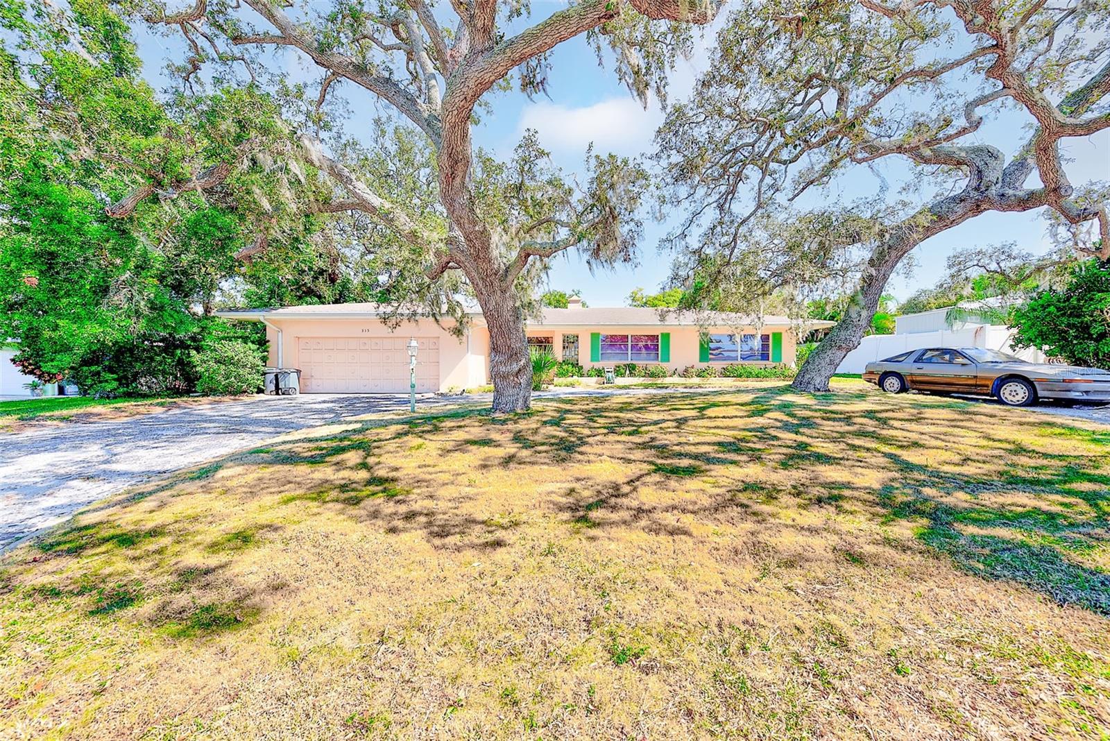 Nestled among majestic oak trees in the highly sought-after Harbor Bluffs community, this 3-bedroom, 3-bath, 2-car garage home presents a rare opportunity to own in one of Largo’s most desirable neighborhoods. Owned by the same family for over 35 years, this property has been lovingly cared for and is livable as-is, yet ready for a full renovation—making it the perfect opportunity for a buyer eager to add value and customize to taste.
The home offers over 2,000 sq ft of living space with a spacious and versatile layout, including formal living and dining areas, a bright family room with walls of windows overlooking the backyard, a large kitchen with ample cabinetry, and an interior laundry room with sink and additional storage. The primary suite features direct access to the backyard, a large walk-in closet, and an oversized bath with both jetted tub and shower. Two additional bedrooms and baths offer great flexibility for family or guests.
Outside, the property’s large lot offers plenty of room to add a pool or outdoor living area, surrounded by mature landscaping for shade and privacy. The circular driveway provides convenience and curb appeal, while the covered front porch adds a touch of mid-century charm.
Located in a no-flood zone above the flood plain, the home sustained no damage in last year’s storms and is part of a deed-restricted community with a low annual HOA. With a potential post-renovation value easily exceeding $700,000, this property is ideal for cash buyers, investors, or those using a renovation loan.
Centrally located, Harbor Bluffs offers an unparalleled lifestyle—just minutes from award-winning Gulf beaches, boating, golf, fine dining, shopping, and world-class medical facilities. This is your chance to own a piece of Harbor Bluffs and transform this well-built home into a showplace.