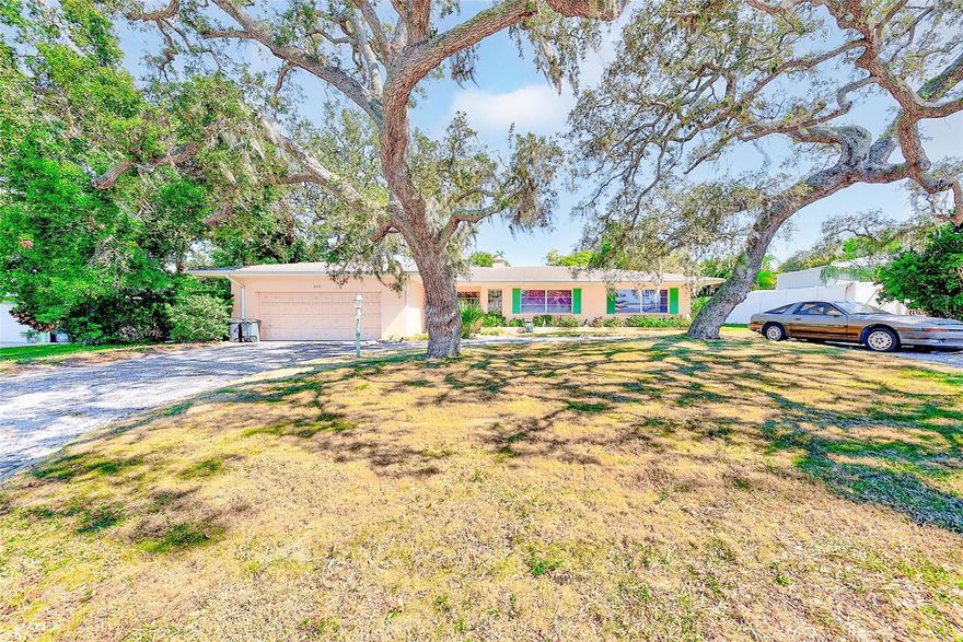 Nestled among majestic oak trees in the highly sought-after Harbor Bluffs community, this 3-bedroom, 3-bath, 2-car garage home presents a rare opportunity to own in one of Largo’s most desirable neighborhoods. Owned by the same family for over 35 years, this property has been lovingly cared for and is livable as-is, yet ready for a full renovation—making it the perfect opportunity for a buyer eager to add value and customize to taste.
The home offers over 2,000 sq ft of living space with a spacious and versatile layout, including formal living and dining areas, a bright family room with walls of windows overlooking the backyard, a large kitchen with ample cabinetry, and an interior laundry room with sink and additional storage. The primary suite features direct access to the backyard, a large walk-in closet, and an oversized bath with both jetted tub and shower. Two additional bedrooms and baths offer great flexibility for family or guests.
Outside, the property’s large lot offers plenty of room to add a pool or outdoor living area, surrounded by mature landscaping for shade and privacy. The circular driveway provides convenience and curb appeal, while the covered front porch adds a touch of mid-century charm.
Located in a no-flood zone above the flood plain, the home sustained no damage in last year’s storms and is part of a deed-restricted community with a low annual HOA. With a potential post-renovation value easily exceeding $700,000, this property is ideal for cash buyers, investors, or those using a renovation loan.
Centrally located, Harbor Bluffs offers an unparalleled lifestyle—just minutes from award-winning Gulf beaches, boating, golf, fine dining, shopping, and world-class medical facilities. This is your chance to own a piece of Harbor Bluffs and transform this well-built home into a showplace.