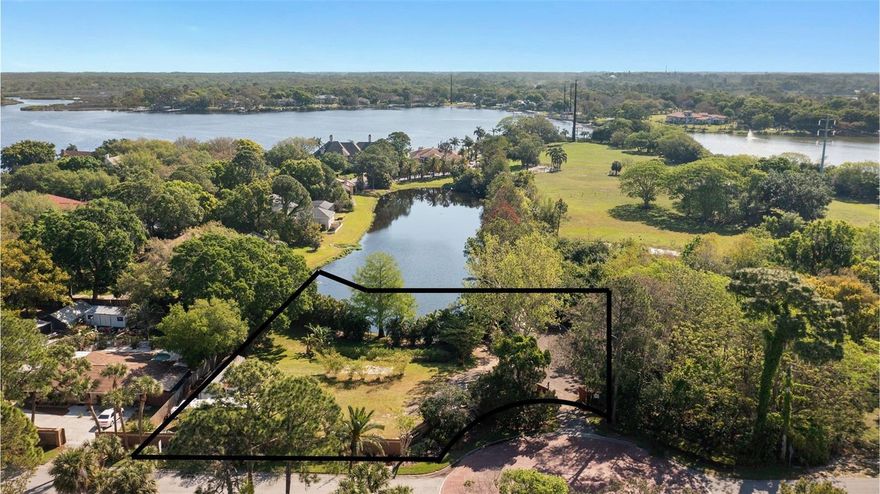 MOTIVATED SELLER! Don’t miss this rare opportunity to own nearly 1 acre of prime land with water views, full fencing, and utilities in place—ready for your dream home! Located in a desirable area surrounded by estate-style homes, this impressive 0.97-acre residential lot delivers a perfect blend of tranquility, privacy, and convenience.

From the moment you arrive, you’ll appreciate the thoughtful improvements already completed. The property is fully fenced with a privacy brick wall and double gated entry, creating both security and sophistication. It features a 900-gallon septic tank, city water, irrigation, two electric connections (100 amps each), a large insulated shed with A/C and power, and an RV hookup—everything you need to start enjoying the property right away.

Wake up to stunning pond and water views and soak in the beauty of the lush tropical landscape, including palm trees, banana trees, and bamboo. At the end of Mary Lane, you’ll also find lake access to the 73-acre Salt Lake, perfect for kayaking, paddleboarding, or simply relaxing by the water.

With NO HOA, NO CDD, and NO flood zone, you have the freedom to design and build your ideal retreat—whether that’s a luxury residence, a modern farmhouse, or a private equestrian escape. Zoned R-E (Residential Estate), this parcel allows for agricultural use and livestock for personal enjoyment—bring your horses, chickens, or garden dreams to life!

The property also includes a rebar-reinforced gravel driveway, RV, and shed, all part of the sale. Plus, approved architectural plans are available upon request—saving you both time and money if you’d like to build immediately.

Situated within 5 miles of world-class golf courses such as Innisbrook, Wentworth, Lansbrook, Crescent Oaks, and Cypress Run, and only minutes to Howard Park Beach, this property offers an unbeatable lifestyle surrounded by recreation, nature, and upscale amenities.

Whether you’re ready to build now or invest for the future, this property offers outstanding potential in a beautiful, established area. Opportunities like this—nearly an acre with existing utilities, mature landscaping, and water access—rarely become available.

The seller is motivated and ready to make a deal—bring your offers today!