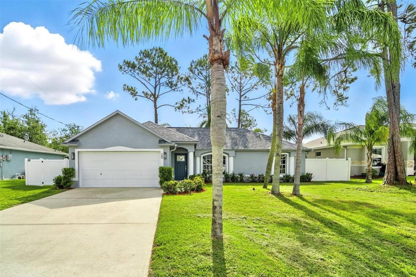 One or more photo(s) has been virtually staged. NEW Roof, NEW A/C, NEW kitchen With Granite CounterTop, NEW Stainless Steel Appliances, NEW Tile, NEW Bathrooms, NEW Lights, NEW Laminate Flooring, NEW Fence, NEW Grass, NEW Irrigation System, NEW Paint Inside and Outside, NEW Knock-down Ceiling. Welcome to this stunning custom-built landmark home in one of Palm Coast’s most desirable neighborhoods — a residence that perfectly blends modern design, full renovation, and timeless comfort. With 3 bedrooms, 2 bathrooms, and a 2-car garage, this property isn’t just move-in ready — it’s been completely reimagined into a showcase of style, light, and quality. From the moment you step inside, you’ll feel the unique character of this home. Expansive windows, rounded corners, soaring ceilings, and an abundance of natural light create an airy, uplifting atmosphere throughout. The thoughtful split floor plan offers both openness and functionality, featuring a separate dining room, family room, living room, and breakfast nook, giving you versatile spaces for everyday living and entertaining. The living room, centered cozy fireplace, flows seamlessly through French doors onto the covered screened porch, excellent for evenings under the Florida sky and barbeques with friends and families. At the heart of the home is a designer kitchen, fully remodeled with high 42-inch solid wood cabinetry, granite countertops, and premium Samsung stainless steel appliances. Its modern finishes and clean lines integrate beautifully with the home’s overall contemporary design. The owner’s suite is a personal retreat with a large walk-in closet and a newly remodeled bathroom featuring elegant tilework and modern fixtures. The guest bathroom has also been fully updated with the same designer touch, ensuring harmony in every corner. Practicality meets style with a convenient laundry room with a closet, making everyday living simple and efficient. This home is more than renovated — it’s completely renewed. Among the upgrades are a brand-new roof (2025), A/C (2022), new laminate flooring all over the house, fresh interior and exterior paint, new modern lighting fixtures, new irrigation system, and fresh landscaping with new lush green grass. The brand-new vinyl privacy fence not only frames the yard beautifully but also creates a sense of new privacy and seclusion, with plenty of room for a future pool. And while the updates shine, so does the setting: this property is surrounded by well-kept homes, quiet streets, and welcoming neighbors. It’s a community where pride of ownership is clear, and where this house stands out as a true landmark — a statement home of light, space, and style. This isn’t just another Palm Coast home — it’s a rare opportunity to own a fully remodeled, custom-built masterpiece designed for today’s living. With its abundance of light, modern elegance, and brand-new systems, this home is ready to impress its next owners from day one. Two photos have been virtually staged for visualization only.