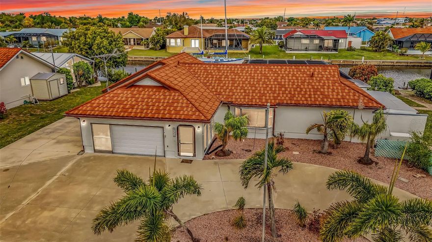 One or more photo(s) has been virtually staged. This stunning waterfront pool home offers the perfect blend of comfort, functionality, and Florida lifestyle living. Featuring three bedrooms and three bathrooms, the home welcomes you with a spacious layout designed for both everyday living and entertaining.  A versatile living room with a built-in bar creates the ideal setting for hosting guests and can easily double as a formal dining space. The expansive family room provides plenty of room to relax, while the kitchen is equipped with a breakfast bar that easily seats 6-8 stools, a pantry with convenient pull outs and a convenient pass-through window to the lanai, perfect for seamless indoor-outdoor entertaining.  The split floor plan ensures privacy, with two guest bedrooms separated by a well-appointed bathroom. The guest bathroom has a linen closet and there is a storage closet in the hall along with a safe that stays with the property.  Bedroom three features a built-in Murphy bed, maximizing flexibility for guests or a home office.  Enjoy true indoor-outdoor living with three sets of sliding glass doors leading to the enormous lanai, complete with a third full bathroom for easy pool access. Additional sliders open directly to the pool area, where you’ll find a beautiful pool featuring a built-in cocktail table with a bench, perfect for relaxing or enjoy the spa that's attached to the pool.  Whether you’re unwinding or hosting, the space is perfectly positioned to take in breathtaking sunset views.  Outside, a charming gazebo ( 11x10 ) enhances the outdoor experience, while the U-shaped driveway and extended rear driveway provide ample parking for guests, boats, or recreational vehicles.  With 100 feet of waterfront, the property includes a dock with two boat lifts (10,000 lb and 8,000 lb), a fish cleaning station, and both water and electric—making it a boater’s paradise with quick access to Charlotte Harbor and out to the Gulf of America.  Additional highlights include a steel tile roof (2023), Electrical sub panel (2023 ) whole-house Generac generator (2022), and a storage shed for added convenience.  Don’t miss the opportunity to own this exceptional waterfront retreat—schedule your private showing today and experience it for yourself.