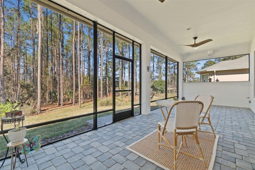 Welcome to refined Florida living in guard-gated Southern Hills, where this 2024 Arthur Rutenberg–built residence sits gracefully on a premium conservation homesite with serene water views. Thoughtfully designed and beautifully finished, this one-story home offers 4 bedrooms plus a private office, 3 full baths, and a 3-car side-entry garage—all wrapped in timeless elegance.
A brick paver driveway and covered front porch set the tone as you step through the striking glass front door into a light-filled foyer with soaring ceilings. Throughout the home, you’ll find classic plantation shutters as well as designer light fixtures and ceiling fans, creating a cohesive and elevated aesthetic.
The heart of the home is the chef’s kitchen, anchored by a large island with rich blue cabinetry, quartz countertops, and an oversized stainless sink. Surrounding cabinetry in crisp white features crown molding, under-cabinet lighting, and gold hardware, complemented by a decorative tile backsplash. Sleek stainless steel appliances including a built-in oven and microwave, 5-burner cooktop, range hood, fridge and dishwasher complete the look. Spacious walk-in pantry is a fantastic bonus feature. Adjacent dining area features French doors leading to the outdoor living space, enhancing indoor-outdoor flow. Luxury vinyl plank flooring flows seamlessly through the foyer, kitchen, family room, and dinette. The family room is both inviting and impressive, highlighted by a double tray ceiling, built-in Sonos speaker system, and a wall of sliding glass doors offering breathtaking views of the wooded backyard—perfect for everyday living and entertaining alike. 
Step outside to the covered and screened brick-paver patio, already pre-plumbed for an outdoor kitchen, where you can relax and enjoy peaceful conservation and water views year-round.
Double doors open to a private home office, ideal for working from home or a quiet retreat. The primary suite is a true sanctuary with a tray ceiling, spacious walk-in closet with window and custom organization, and a spa-inspired en-suite bath featuring a freestanding soaking tub, expansive walk-in shower, and dual vanities.
One guest bedroom offers a private en-suite bath with walk-in shower, wood cabinetry, and granite counters—perfect for guests or multigenerational living. Two additional bedrooms share a well-appointed full bath with a walk-in shower. The laundry room is thoughtfully finished with a sink and granite countertops.
The side-entry 3-car garage features an epoxy floor and houses the water softener and conditioning system, blending function with polish.
All of this is located within Southern Hills, a premier resort-style community offering a luxury pool, fitness center, pickleball courts, clay tennis courts, walking trails, clubhouse with restaurant, and a championship golf course!
This exceptional home delivers new construction quality, designer finishes, and resort living—all in one of Brooksville’s most coveted communities.