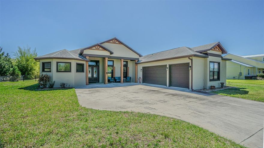 Want ROOM TO ROAM that is Country Close?  Your search is over!  Must see this exceptional custom-built 4 bedroom, 3 bath, 3 car garage home, perfectly positioned on a full acre just outside the city limits of San Antonio, Florida in the GATED Community of Kumquat Landings—where you’ll enjoy NO CDD fees and a low annual HOA.  Cedar covered front entrance adds to the curb appeal inviting you to enter thru the double doors!  Built in 2018 by Joshua Gilman, this thoughtfully designed residence offers a spacious open floor plan ideal for entertaining family & friends, featuring high-end laminate flooring and tile throughout, soaring 14-foot ceilings, crown molding, transom windows for added natural light and a light, bright, energy-efficient feel with tinted windows.  Casual Elegance abounds in the expansive great room which flows into the dining area and is OPEN to a stunning chef’s kitchen, complete with granite countertops, custom dove-tailed wood cabinets, subway tile backsplash, two GE wall ovens, a massive island with contrast tile base, pendant lighting, a stainless steel farmhouse sink and seating for six, plus a HUGE walk-in pantry large enough for a freezer or 2nd refrigerator.  A flexible space off the kitchen provides endless possibilities for a breakfast nook, a play area, or even a wet bar. The split-bedroom layout ensures privacy, with a luxurious owner’s retreat overlooking the large backyard and featuring a spa-like ensuite with a freestanding elegant soaking tub and a beautifully renovated walk-in shower. The additional bedrooms, one set up as a home office, the other as a guest bedroom at the rear, are generously sized and filled with natural light, while ceiling fans throughout the home and on the screened back porch enhance comfort year-round. Outdoors, the property is just as impressive with a fenced yard, irrigation system, firepit area, clumping bamboo for privacy, and a screened lanai overlooking the expansive backyard, already wired for a future pool and outdoor kitchen. Car enthusiasts, hobbyists, and those needing extra storage will appreciate the impressive 24x30 metal building/workshop on a concrete slab, complete with two 10-foot roll-up doors, foam insulation, metal roof, windows for natural light, 30,000 BTU mini-split AC, water, utility sink, electric, internet, and a 220V RV hookup, along with additional parking space for trailers, RVs, or equipment. Additional highlights include a whole-house 22KW Generac generator with buried propane tank, CareSoft Elite water filtration system, gutters, plantation shutters, interior laundry room with utility sink and storage, well and septic, 2019 AC, and exterior security cameras that convey. Located North of Tampa near Wesley Chapel and Dade City with easy access to shopping, outlets, restaurants, medical facilities, fitness and major highways for easy commute to work, Ocala, Orlando, Tampa, Airports or the Gulf Beaches! This one-of-a-kind property truly offers the life you want, county zoned... an ideal place to call home!  CALL TODAY!