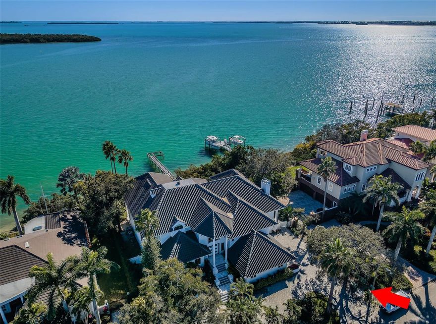 LOCATED IN ONE OF TAMPA BAY’S BEST BOATING COMMUNITIES, THIS DAZZLING 6 BEDROOM 6 ½ BATH WATERFRONT ESTATE PROVIDES AN IMPRESSIVE 6424 SQFT OF LIVING AREA.  A grand circular driveway introduces a towering covered entry and a soaring 20ft-high foyer with lovely views of the waterfront.  Magnificently remodeled with an inspiring coastal contemporary flare, you will be taken-back by striking large-format porcelain floors and luxury vinyl floors, high ceilings, unique geometric patterns and radiant modern lighting.  Overlooking the waterfront, the sumptuous open-concept designer chef’s kitchen boasts 21ft-high ceilings, superb quartz counters, high-end SS appliances, built-in refrigeration, gas cooking, coastal white cabinetry, huge island bar/serving center with quartz waterfall counters, wine chiller and dedicated ice maker.  Complementing the kitchen is a matching full appliance/full function butler’s pantry.  Gas fireplace with custom mantle transitions to an open waterfront dining area and your back yard oasis.  The well-appointed pool bath includes a posh walk-in glass rainshower enclosure. Your exceptional living room has wonderful waterviews and opens to the pool deck.  You will appreciate the sizable executive office with fireplace and finely-tiled adjacent guest bath.  The huge owner’s suite with expansive walk-in closet, has brilliant views of the intracoastal waterway and private access to the pool deck.  The modern owner’s bath is truly stunning – elegant floor-to-ceiling tilework, two minimalistic vanities with quartz surfaces, stand-alone deluxe soaking tub, and an enormous walk-in glass rainshower enclosure with multiple rainshower heads. Isolated to a part of the home with separate exterior access, the spacious guest suite contains three closets and a beautifully-tiled full guest bath.  Step up to the upper bedroom level with generously-sized loft overlooking the kitchen and the waterfront.  Oversized matching waterfront bedrooms with walk-in closets, are joined by a gorgeous full bath, and share a 28ft-wide covered balcony with commanding views of the water.  Two additional bedrooms are supported by a remarkably-luxurious full guest bath with floor-to-ceiling tilework, lavish dual vanities, stand-alone soaking tub, and an exquisite walk-in glass shower enclosure with dual shower systems.  The upper-level bonus room - ideal as a game, fitness or media room – also features a splendid full bath.  Step out back to the fabulous deck with its richly-tiled swimming pool and spa, and deck space for more than a dozen loungers.  Attached to the home is an 18ft-high, 250sqft covered gazebo-like dining and lounging area with terrific views of the waterfront.  Outside the owner bedroom is a 28ft-wide covered lounging/seating deck.  Beyond the pool deck is the composite dock that walks you out to the open waterway.  Home has a newer roof (2023) and a large laundry/utility room, and enjoys tremendous auxiliary storage space and substantial parking. This is an outstanding luxury waterfront value in one of the easiest commuting waterfront locations in all of Tampa Bay. Close to I275 - reach the beaches in 4 min, downtown St. Pete in 10 min, Tampa Airport in 25 min. and Sarasota in 40 minutes.  Buyer to verify dimensions.