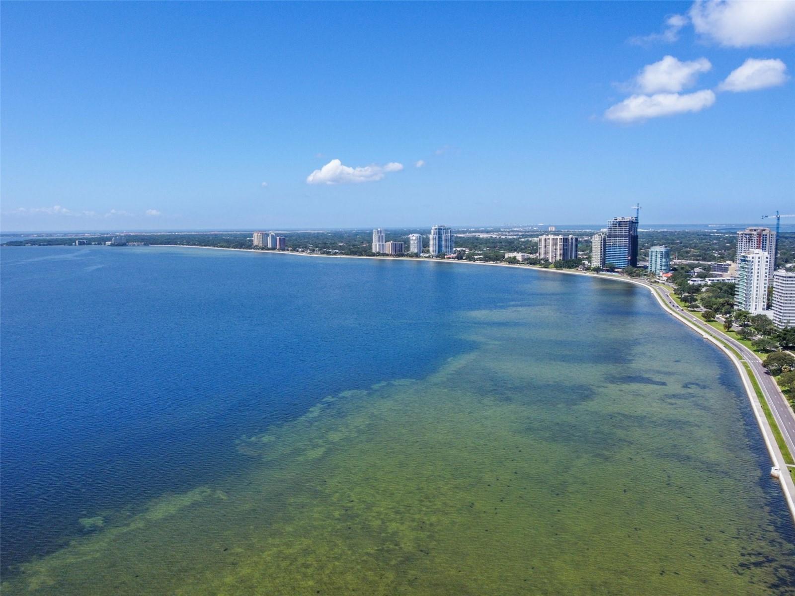 Indulge in the opulent lifestyle of Atrium Bayshore; where the 8th floor front-facing views of the magnificent Tampa Bay are yours to behold. Behold the perfect location overlooking the iconic Bayshore Blvd; bask in the beauty of the sunrise and marvel as storms roll in, all while enjoying an unparalleled front-row seat to the famed Gasparilla festivities!
Upon entry, you are greeted with an expansive open floor plan, adorned with floor-to-ceiling hurricane impact sliding doors and windows. The current owners have spared no expense in upgrading all of the sliders and windows to provide an exceptional living experience. The sleek galley kitchen flows effortlessly onto your wrap-around balcony, perfect for dining with a view!
The airy and luminous open floor plan of this exalted residence is inundated with natural light throughout the living, dining, and additional sitting/home office spaces. The ensuite primary bedroom and guest bed/bath are just down the hallway, each featuring their own sliders onto the balcony, allowing you to relish in the breathtaking views from the comfort of your own bed.
Immerse yourself in the coveted Tampa lifestyle, the building features 24-hour security, tennis courts, pool, and covered parking. This unit includes two assigned parking spaces. Revel in the convenience of being in the heart of it all, with close proximity to Howard Ave's restaurant row, downtown Tampa, Hyde Park Village, and so much more.