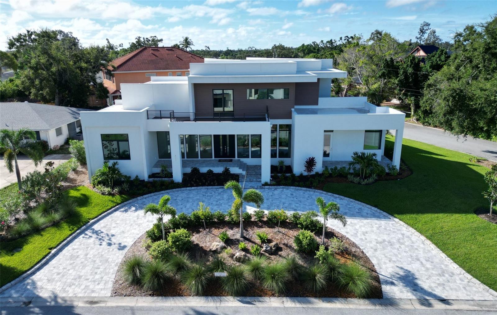 One or more photo(s) has been virtually staged. Stunning New Custom Home – Mid-Sarasota County – COQUINA ISLAND! Move In Ready.
This one-of-a-kind, executive home is located on a spacious lot in the heart of Sarasota County on Coquina Island, offering modern luxury and timeless design. Situated just minutes from Siesta Key Beach, top-tier shopping, dining, Sarasota Memorial Hospital, Selby Gardens, and downtown Sarasota’s Marina Jack’s, this home enjoys a prime location.
Key Features:
4 or 5 Bedrooms | 5 1/2 Bathrooms
38' Wide Polyaspartic Garage with high ceilings, music speakers and 2 ceiling fans (space affords lifts in each bay)
13' High Ceilings in the great room
Gourmet Kitchen with sleek appliances, large island, cooktop hood, double wall ovens, coffee bar, and expansive walk-in pantry with custom shelving and room for a full freezer or refrigerator.
Spacious Master Suite with walk-out lanai, his and hers walk-in custom closets
Private Outdoor Spaces including multiple decks and a large paver lanai overlooking the Pebble-Tec heated saltwater pool with spillover spa
Separate Suite above the garage with a full kitchen, bath, bedroom, laundry, and balcony—perfect for guests or as an in-law suite
Energy Efficient with Icynene insulation, soundproofed walls, and potential for solar power
3 HVAC units and zones
Instant hot water heater; separate water heater for guest or in-law suite
Interior Highlights:
High-end finishes and custom-built staircases
Wood and tile floors throughout
Floor-to-ceiling windows flood the home with natural light
Fully structured wiring for sound; 19 music speakers and security cameras
Large laundry room with custom cabinetry, laundry sink, folding counter and hanging rod
Spacious pantry with custom shelves; electric dedicated circuit for additional freezer and/or refrigerator
Insulation in walls & ceiling for sound mitigation
WiFi mesh
Outdoor Oasis:
Heated Saltwater Pool & Spa with spillover waterfall and floor clean system
8 Outside security cameras
Outdoor Kitchen featuring marine-grade cabinets and a granite composite sink
Professionally designed tropical gardens with private well for the sprinkler system
LED Lit Circle Paver Driveway adds striking curb appeal
The home has been specifically designed for its setting and offers incredible potential for a variety of uses—whether as your dream family home or a unique investment opportunity. Sellers are flexible in considering offers to accommodate buyer wants and needs. Possible deeded access to Phillippi Creek via easement.