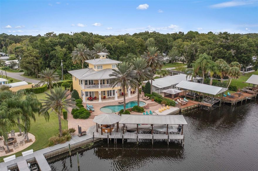 Welcome to 56230 Redbud Road - a riverfront Key West style pool home with 6 bedrooms, 4.5 baths, over 4200 square feet of living space, and 100 feet of water frontage. Custom built and thoughtfully planned in 2007, this home is the perfect place to gather on weekends and holidays. The first level of the home is perfect for guests and entertaining as it includes a full kitchen, two bedrooms, and direct access to the backyard and pool. The second and third levels are the main living quarters - the main kitchen is located on this level with custom-built cabinetry, Viking appliances all overlooking the family room, massive patio with gorgeous river views. There are 4 bedrooms on this level including the primary suite with a gas fireplace, private patio entrance, walk-in closet, and beautifully appointed bath. The third level of this home is a fabulous parlor with a full-sized built-in bar - all levels are accessible by the elevator. No detail was overlooked - the custom millwork is extensive throughout the home. The deep water boat house with a lift is ready for your large boat with a full-sized bar ready for the party. Additional highlights include two oversized garages, 4 HVAC units, and a generator. This is a wonderful opportunity to purchase that dream vacation home - you can even Air BnB for additional income. Please ask about the adjoining lot that is available for purchase with this home.