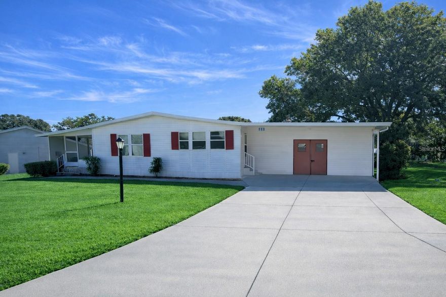 Welcome to easy Florida living in the sought-after Plantation at Leesburg, a guard-gated 55+ golf community in the heart of Lake County. Situated on a quiet corner lot, this well-maintained 2-bedroom, 2-bath manufactured home offers comfort, functionality, and peace of mind with recently updated skirting and tie-downs, providing enhanced stability and long-term value.

Inside, you’ll find new flooring in the living room, fresh interior paint, and a flexible indoor laundry/office space ideal for hobbies or working from home. The home also features a bright sunroom and an attached workshop, perfect for storage, projects, or extra usable space.

Plantation at Leesburg is known for its active lifestyle and impressive amenities, including three clubhouses with on-site activity directors, three community pools, a restaurant and lounge, walking trails, pickleball, tennis, golf, a fully equipped woodworking shop, and convenient RV and boat storage on property. Residents enjoy the security of a 24-hour manned gate and a low HOA that supports a vibrant, resort-style lifestyle.

Ideally located just minutes from The Villages, with easy access to Orlando International Airport, Disney, Universal Studios, and both Florida’s east and west coast beaches, this home offers the perfect blend of relaxation, recreation, and convenience.

Whether you’re seeking a full-time residence or a seasonal retreat, this home is a fantastic opportunity to enjoy one of Central Florida’s premier 55+ communities.