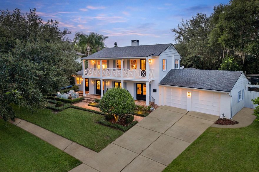 Exuding timeless charm and Southern elegance, this gorgeous Charleston-style residence sits on a large lot overlooking the tranquil waters of Lake Knowles. Framed by a picturesque brick street lined with beautiful homes, the property boasts striking curb appeal, a 32-foot second-story porch with breathtaking sunset views, and classic architectural details that invite you in at every turn. A charming brick firepit area in the front yard offers a spot to gather on cool evenings while taking in peaceful lake vistas. Thoughtfully renovated, the home seamlessly blends modern comforts with preserved character, including gleaming hardwood floors, French doors, and a welcoming, light-filled layout. The front living room is anchored by the home’s original 1954 wood-burning fireplace, a timeless centerpiece flanked by built-in shelving. It's a spot to curl up with a good book, open all three sets of French doors, and enjoy the crisp air and sparkling views of Lake Knowles. Whether you're sipping cocktails on a winter evening or coffee on a quiet morning, the space offers a special setting. For over 50 years, residents have gathered to admire the beloved Lake Knowles Christmas tree, its colorful lights casting a magical glow across the water—just one of many traditions that make this location so cherished. A family room flows into the dining room, where French doors lead to a charming brick patio for effortless indoor-outdoor entertaining. The chef’s kitchen is a dream, featuring top-of-the-line appliances, a generous island with seating, a walk-in pantry, and a stylish dry bar that connects to the kitchen and living room. The first-floor primary suite offers a serene retreat with French doors opening to the patio, dual closets (including a walk-in), and a luxurious bath with a large glass shower, dual sinks, and a private water closet. Upstairs, two additional bedrooms and a cozy den or TV room provide inviting spaces for family and guests. The third bedroom includes a spacious walk-in closet and an en-suite bath, while the second-story porch offers an idyllic vantage point for sunset views over the lake. Outside, the backyard is an oasis with a sprawling lawn, mature landscaping, and plenty of room to add a pool. Just a short bike ride from Park Avenue’s boutiques, fine dining and Central Park, the home is also minutes from the weekly Farmer’s Market, top-rated schools, and major roadways for easy access to downtown Orlando, international and executive airports, and leading hospitals.