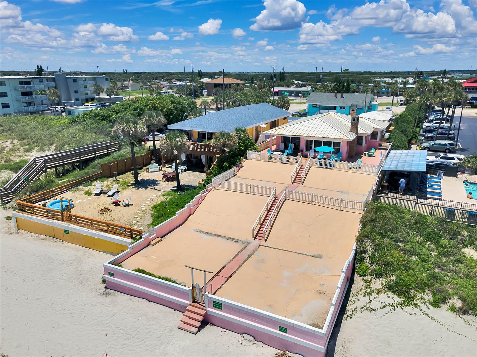 This property is directly on the Ocean and famous New Smyrna Beach featuring Million dollar views of the Atlantic Ocean and up and down the white sandy beach. It is ZONED B-4 Oceanfront which is the most desirable for Business and development. This is the only B-4 Oceanfront available in New Smyrna Beach, and perhaps the entire central Atlantic coast. The house is solid Concrete with a huge concrete patio facing the Ocean. Seawalls on the East facing the ocean, a return on the north, and the adjacent property's seawall offer the protection from storms along with the hurricane shutters inside the main building. Separate building is the RV Garage on the street side which has been converted to a Mother-in-law suite with an outdoor private patio and 2nd floor ocean view terrace. The main house consists of 3 Bedrooms, 2 Baths, laundry room, storage room, single car garage. Currently has a Short term rental business which new owner can take over and continue as they also enjoy staying on the beach. The rarest opportunity you will find. ;Water: City