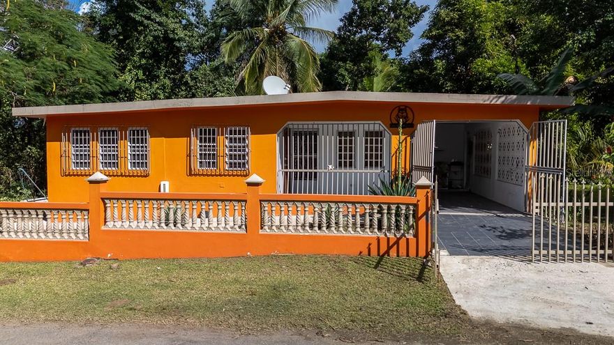 This solid all-concrete home is tucked away on a quiet side street just off Route 200, offering a peaceful setting while remaining centrally located on Vieques’ north shore. Less than a five-minute walk brings you to El Gallito Beach, making daily beach access easy and effortless.

The property offers flexible use as either a single residence or a multi-unit layout, with a separating door in the shared living area. The main home features two bedrooms and two bathrooms, including an en-suite bath. A separate studio/efficiency unit includes its own full kitchen, bathroom, and private exterior entrance—ideal for guests, rental income, or extended family.

Set on nearly one-third of an acre, the property includes two adjoining lots sold together. The home sits on Lot A, with Lot B providing additional yard space and a creek along the rear of the property. Mature shade trees, awapuhi ginger, and banana plants enhance the natural surroundings.

Located on a corner lot across from the former W property, this home is just minutes from Isabel Segunda and the airport, combining convenience with a quiet residential feel. A large marquesina/carport houses the laundry area and offers potential for additional usable space.