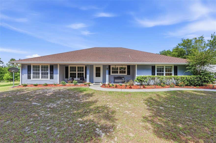 Welcome to your private retreat! This 3-bedroom, 2-bath home + office sits on over 6 beautiful, fully fenced acres with Santa Fe river access, offering the best of peaceful country living just minutes from downtown Alachua and High Springs. Set back off a paved road with a private drive, the home boasts excellent curb appeal, fruit trees, and an adorable front porch that invites you in. Step inside to a bright office filled with natural light, perfect for working from home. The spacious living room features vaulted ceilings, a cozy brick fireplace, and opens to a large screened-in back porch with stunning backyard views—ideal for relaxing or entertaining. The kitchen is a chef’s dream, complete with a large island with seating, ample counter space, and a big window over the sink that overlooks the front yard. The kitchen flows seamlessly into the generous dining area. A split floor plan ensures privacy, with a roomy master suite offering tray ceilings, direct access to the screened porch, and a luxurious en suite bath with dual sinks, abundant storage, and a jacuzzi tub. Additional features include a 2-car garage, a detached matching shed with power—perfect for hobbies or a workshop—plus two separate carports to store all your vehicles, boats, or toys. All of this is conveniently located near I-75, top colleges, hospitals, and North Florida’s famous rivers and springs. This property combines comfort, space, and natural beauty—schedule your showing today!