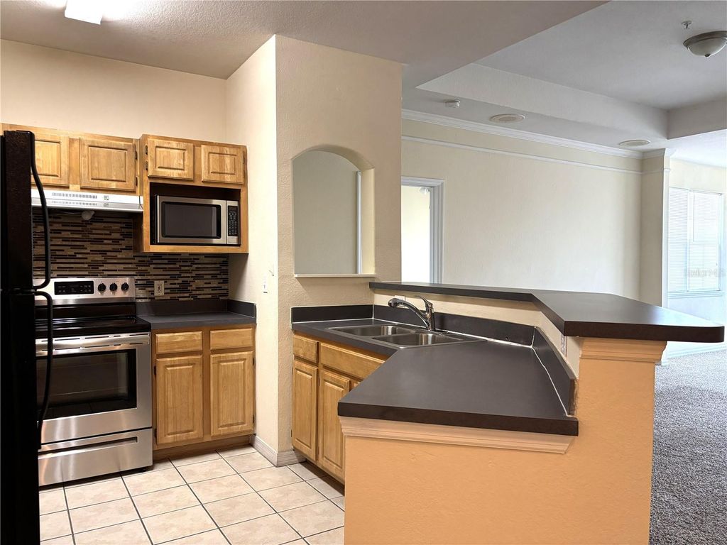 Photo of 6663 Queens Borough Avenue #303, Orlando, FL 32835 (MLS # O6407256)
