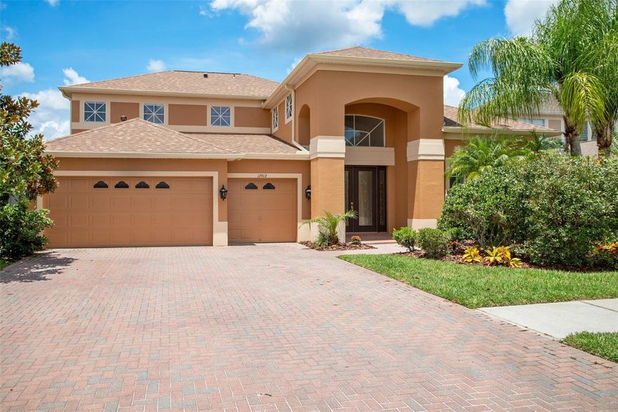 Welcome to New Tampa's premier Ski Lake community! This executive home features 4 bedrooms, a bonus room, study, 3 full baths, and 3-car garage. As you enter through the elegant double doors, you will be greeted by a two-story foyer and gleaming porcelain tile flooring throughout the first floor. Walk through this open floor plan that features a formal living and dining room leading to a well-appointed gourmet kitchen offering 42” wood cabinetry, exquisite granite countertops & backsplash, walk-in pantry, and a breakfast nook with bay windows overlooking the great room. The very spacious family/great room has expansive sliding doors offering panoramic views of the pond and breathtaking sunset colors right from the comfort of your couch! Continue to enjoy the water view from the master bedroom on the first floor. The master suite has walk in closets, dual sinks and vanities and a jacuzzi. The stairs lead to a bonus room with French doors. There are three additional bedrooms upstairs and a jack and jill bathroom with double vanities. The second floor also features a flex area for a home gym, study, meditation room or a play area. This home is move-in ready and loaded with upgrades. It features recessed lights in every single room of the house. If you are looking for a like-new move-in ready home, you are sure to fall in love with this house! Cory Lake Isles features a pristine 165-acre lake, brick-paved streets, a resort-style pool with slide, multiple tennis courts, beach volleyball, playgrounds, basketball court, hockey rink, fitness center. easy access to several walking trails of Flatwood Preserves and a world class clubhouse for entertainment! Cory Lake Isles is centrally located with easy access to highways and proximity to USF, VA Hospital, Moffitt Cancer Center, Advent Health, Tampa Premium Outlets, movies, restaurants and more!
