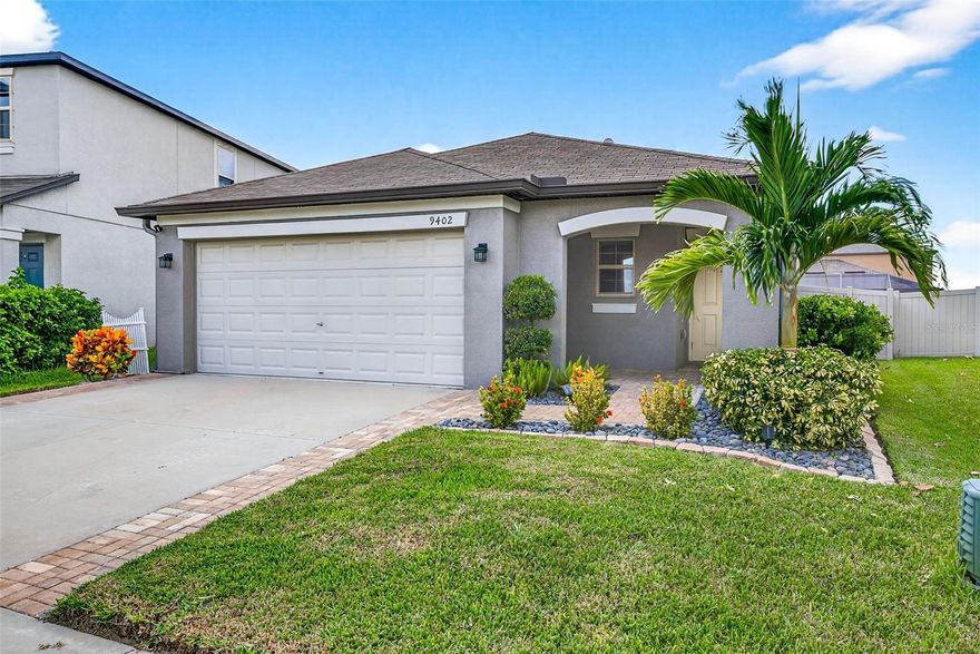 This meticulously cared-for, move-in ready home offers the feel of new construction with no history of storm damage. Featuring an open floor plan with high ceilings and abundant natural light, the interior boasts ceramic tile in main areas and luxury vinyl flooring in bedrooms—NO CARPET throughout. The kitchen is equipped with granite countertops, tile backsplash, a large center island, stainless steel appliances, and a gas range powered by natural gas, complemented by a tankless water heater for energy efficiency. The bright laundry room includes a window and the included washer and dryer is great to use on top for folding laundry.  Light dimmers in the kitchen and dining area add ambiance. All storage shelves throughout the home remain, and a heavy-duty TV wall bracket is already installed for convenience. The front yard showcases low-maintenance landscaping with large decorative rocks and colorful plants accented by Florida Christmas Palms. PAVER ENTRY and PAVERS on each side of driveway.  Step outside the back sliders to a spacious paver patio and fully fenced backyard with vinyl privacy fencing. Additional features include a water softener, irrigation system for the entire lawn, in-wall pest tube system, storm panels to protect windows, Ring doorbell, and front security camera. Located close to shopping, restaurants, schools, parks, and easy access to I-75, Hwy 41 & 301.  This home also offers a rare  ** 3.25% VA ASSUMABLE MORTGAGE for qualified veterans. ** Enjoy resort-style community amenities including two pools, a tot-lot, tennis courts, cabana, scenic pond views with sitting areas, dog park, and walking trails.