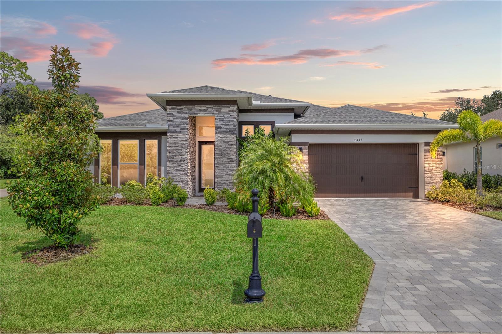 Welcome to 13444 Trailing Moss, a stately residence on a large 1/3-acre corner lot in the prestigious Lake Jovita Golf & Country Club, an upscale, guard-gated community. Known for its scenic rolling hills, sparkling lakes, and resort-style amenities, Lake Jovita features two championship golf courses, tennis and pickleball courts, a fitness center, a community pool, a new dog park, and a beautiful park that sits right in your backyard. The South Course has even hosted USGA U.S. Open local qualifying events, adding to the community’s prestige.
With over 3,000 square feet of living space on a single-story floor plan, this home was designed for both elegance and functionality. The upgraded layout includes three spacious bedrooms, three full bathrooms, and an expanded bonus room with stylish barn doors—perfect for entertaining, a media lounge with surround sound, or even a private retreat. Plus, there’s an additional home office at the front of the home with upgraded hardwood floors, ideal for those working remotely or needing a dedicated workspace. The split-bedroom layout offers exceptional privacy, and the master suite is a true retreat with a spa-like ensuite featuring a free-standing soaking tub, dual vanities, and a massive walk-in closet. At the heart of the home lies the chef’s kitchen, designed to impress both everyday cooks and gourmet entertainers. Outfitted with 42-inch soft-close cabinets and custom uppers, this kitchen offers ample storage and timeless style. The elegant cabinetry is paired with sleek quartz countertops, a large center island with bar seating, and upgraded stainless steel appliances, making meal prep and hosting a delight. Thoughtful touches like a walk-in pantry and custom lighting add both convenience and character.
Soaring 12-foot ceilings in the common areas, paired with 10-foot ceilings in the bedrooms and 8-foot doors throughout, create an open, airy atmosphere that enhances the home’s sense of space and luxury. The family room showcases a panoramic slider, allowing seamless indoor/outdoor living and perfect views of the backyard retreat. Step outside into your own private resort. In the expansive backyard, you’ll find a dreamy heated saltwater pool and spa, fully screened-in for year-round enjoyment. The outdoor cooking area is perfect for poolside dining, while the home’s unique location backing up to the park allows you to stroll straight from your backyard into the community’s green space. Additional highlights include exquisite trim work throughout, a three-car tandem garage with abundant storage, an electric vehicle charger, and a whole-home water softener for added comfort. Every detail has been thoughtfully curated to blend luxury, practicality, and timeless style. At 13444 Trailing Moss, you’ll enjoy the perfect balance of refined living and relaxed Florida charm, all in one of the Tampa Bay area’s most sought-after gated golf course communities.