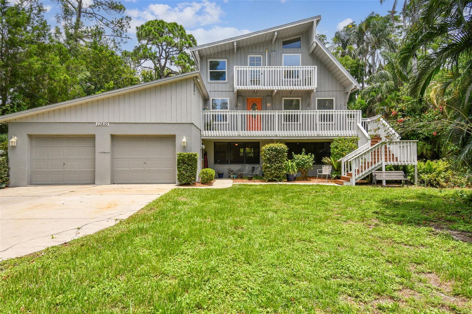 Welcome to this distinctive home in the highly desirable Old Oakhurst area of Seminole. This three-level residence offers over 2,500 square feet of living space, featuring four bedrooms, three bathrooms, and a rare bonus: a full second kitchen and living area, perfect for multi-generational living, extra flexibility or income-producing potential. The main floor (second level) is warm and welcoming, beautifully remodeled with modern style and open concept living. Multiple decks expand your living space outdoors. The remodeled kitchen showcases granite countertops, stainless steel appliances, soft-close Shaker cabinetry with crown molding and under-cabinet lighting. A large breakfast bar connects seamlessly to the kitchen and family room, offering abundant seating. Just off the kitchen, an additional living room features a wood-burning fireplace, a wine fridge and easy access to a full guest bathroom. Luxury waterproof vinyl plank flooring runs throughout these living spaces for both beauty and durability. Upstairs on the third level, you'll find three bedrooms, including an oversized primary suite large enough to accommodate a home office. Abundant natural light streams in through doors and windows that open onto Juliet balconies in each of the bedrooms. The updated shared bathroom includes an oversized walk-in shower with direct access from the primary bedroom. The ground floor offers exceptional flexibility as it is considered an accessory dwelling unit with its own living room, dining area, full kitchen, bedroom, and third bathroom—ideal for guests, extended family, or rental possibilities. This level also provides access to two patios, the backyard and the garage. Situated on a very private lot just shy of half an acre, the property is fully fenced—including a gated driveway at the front—and offers ample space to park an RV, boat, or to add the pool and backyard oasis of your dreams. Best of all, this home is high and dry with no flood insurance required. The location can’t be beat – just five minutes to the beach and five minutes to shopping and dining at Seminole City Center. Ready to explore every detail? Take a virtual 3D walkthrough here: https://my.matterport.com/show/?m=sm4FvdLMWmL&mls=1, then schedule your private showing today!
