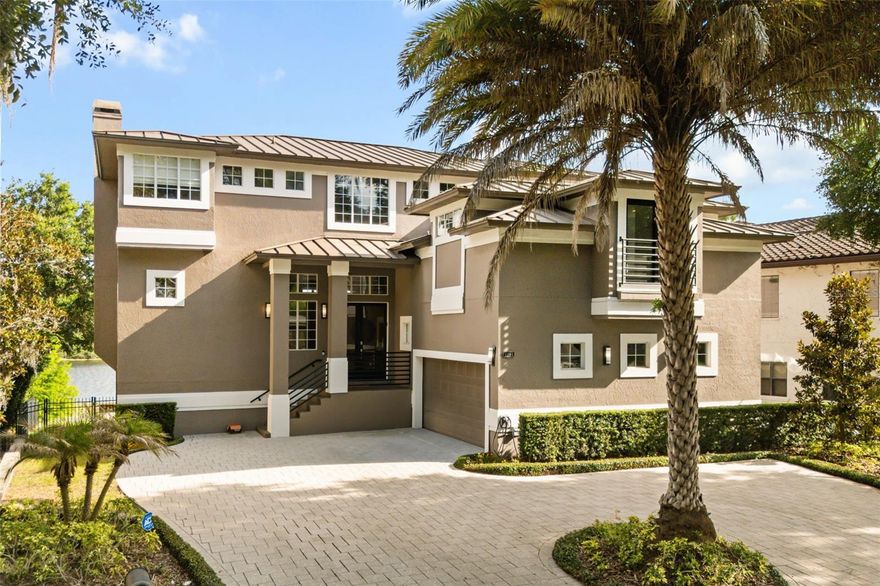 Welcome to luxury lakefront living at its absolute finest in the heart of Maitland, Florida. Nestled along the pristine shores of Lake Sybelia, this extraordinary three-story estate offers an unparalleled combination of elegance, comfort, and breathtaking waterfront views. Boasting 5,355 square feet of thoughtfully designed living space, this stunning residence features six spacious bedrooms, four and a half bathrooms, and an open-concept floor plan perfectly crafted for both entertaining and everyday living. Expansive walls of glass fill the home with natural light while showcasing panoramic lake views from nearly every room.

The main living area seamlessly connects the gourmet kitchen, dining room, living room, and family room, all overlooking the sparkling waters of skiable Lake Sybelia. Designed with indoor-outdoor living in mind, each floor features a balcony spanning the entire width of the rear of the home, creating multiple spaces to relax and enjoy Florida’s spectacular sunsets. Step outside to your private resort-style oasis complete with a gorgeous pool, lush landscaping, and direct lake access with your own private boat dock and lift, perfect for boating, skiing, and waterfront recreation year-round.

The upstairs retreat is anchored by an impressive primary suite featuring serene lake views and private balcony access. The upper level also includes a dedicated private office, ideal for working from home while enjoying stunning lakefront views. Two additional bedrooms share a beautifully designed Jack-and-Jill bathroom, while another flexible bedroom space can easily serve as a nursery, fitness room, or additional guest bedroom. Every level of the home has been carefully designed to maximize comfort, privacy, and functionality while maintaining a sophisticated and timeless aesthetic throughout.

The lower level offers endless entertainment possibilities with a spacious game room, a full movie theatre, an additional guest bedroom, and a full bathroom ideal for visitors or multi-generational living. Completing this exceptional property is a beautiful temperature controlled wine cellar holding almost 2,000 wine bottles, a two-car garage with additional storage space, a large home generator, and countless luxury details throughout. This one-of-a-kind Lake Sybelia estate delivers the perfect balance of upscale living, modern convenience, and the ultimate waterfront lifestyle in one of Central Florida’s most desirable locations.