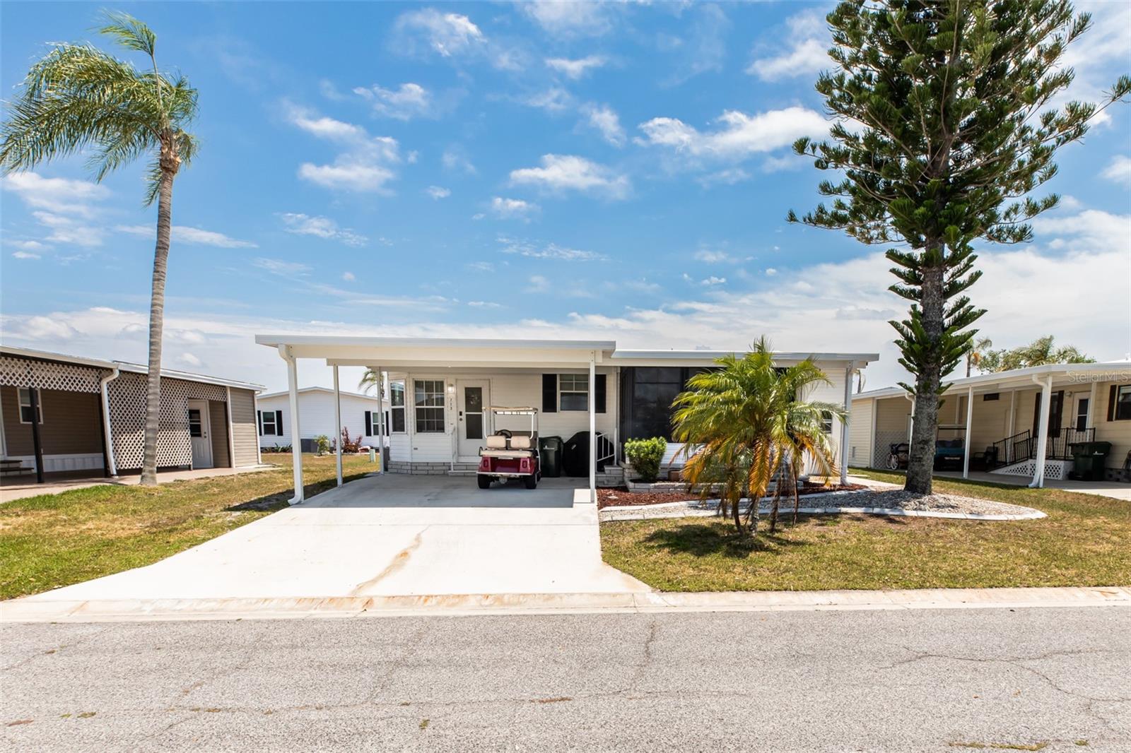 CHARMING FURNISHED 2 Bedroom, 2 Bathroom, Carport manufactured home located in the active 55+ Harbor Cove Community. CLICK ON THE VIRTUAL TOUR LINK 1 FOR THE VIDEO AND VIRTUAL LINK 2 FOR THE 3D TOUR. Spend quality time with friends and family in the open living room while whipping up family favorites in the kitchen. The EAT-IN kitchen offers all-white appliances, granite countertops, a coffee bar, and an off-kitchen dining room. The master bedroom has a walk-in closet and a private bathroom with a single sink vanity and a walk-in shower. The guest room has a built-in closet and a guest bathroom nearby. Expand your living and entertaining space to the screened lanai, where you can sip your morning coffee or unwind with your favorite evening beverage while enjoying the BEAUTIFUL Florida weather. There is a storage room for extra storage space and it doubles as a laundry room. 2024 A/C - 2024 WATER HEATER - 2023 WASHER/DRYER - 2023 RANGE & REFRIGERATOR. Harbor Cove is an active resident-owned WATERFRONT community with a clubhouse, two community pools, an exercise gym, shuffleboard & bocce ball courts, a wood workshop, a private marina, and TONS of resident social events to keep you active year-round! Conveniently located near US 41 for easy access to local shopping, dining, LIVE entertainment, and award-winning beaches. Schedule your private showing TODAY!