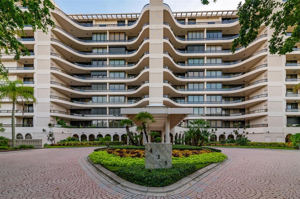 This private oasis blends luxury style with the exquisite tropical beauty of Gulf-front living. Floor-to-ceiling windows throughout and full-height sliders extend the expansive living space to a true wraparound balcony overlooking treetops, manicured grounds, pristine beach and the endless azure of the Gulf. From the semi-private elevator, the entry vestibule opens to a grand open-plan great room with porcelain tile floors and layout ideal for personal comfort and entertaining. The large dining area is distinguished by a modern chandelier and accommodates seating for eight, flowing seamlessly into the enormous lounge and terrace beyond. Recessed lighting, neutral tones and a floating credenza lend minimalist elegance to accentuate the views. A media den adjacent to the living room adds seating and space but can be easily separated, offering versatility as a third bedroom or home office. Designed for optimal efficiency, the designer kitchen features sleek cabinetry, Corian countertops and premium appliances, including double ovens. Sliding doors beside the eat-in breakfast area open directly to the southern-facing terrace. The primary bedroom features Gulf-facing windows and private access to the terrace, along with a massive en-suite bath and dressing room appointed with custom built-in shelving. In the bath, a glass-enclosed shower, floating vanity and separate makeup table are the perfect blend of sophisticated form and function. A guest bedroom with bath and terrace access is situated apart from the owner’s suite and provides a spacious sanctuary, ideal for elegant hospitality. An in-unit laundry room with a utility sink maximizes storage and convenience. This home is a true island paradise of vacation living. Ideally located at the southern end of Longboat Key and adjacent to the Longboat Key Club, L’Ambiance at Longboat Key offers five-star, resort-style living with the highest level of concierge service and gated security. In addition to private beach access, an on-site spa and an exceptionally beautiful pool for lounging and laps, residents can enjoy private Har-Tru tennis courts, a state-of-the-art fitness center and interior amenities, including secure wine lockers, private storage, a shared lounge and entertainment rooms. Privacy is ensured with dedicated resident parking in a secured indoor garage. 24-hour gated security and secured entry with access-restricted elevators. Room Feature: Linen Closet In Bath (Primary Bedroom).