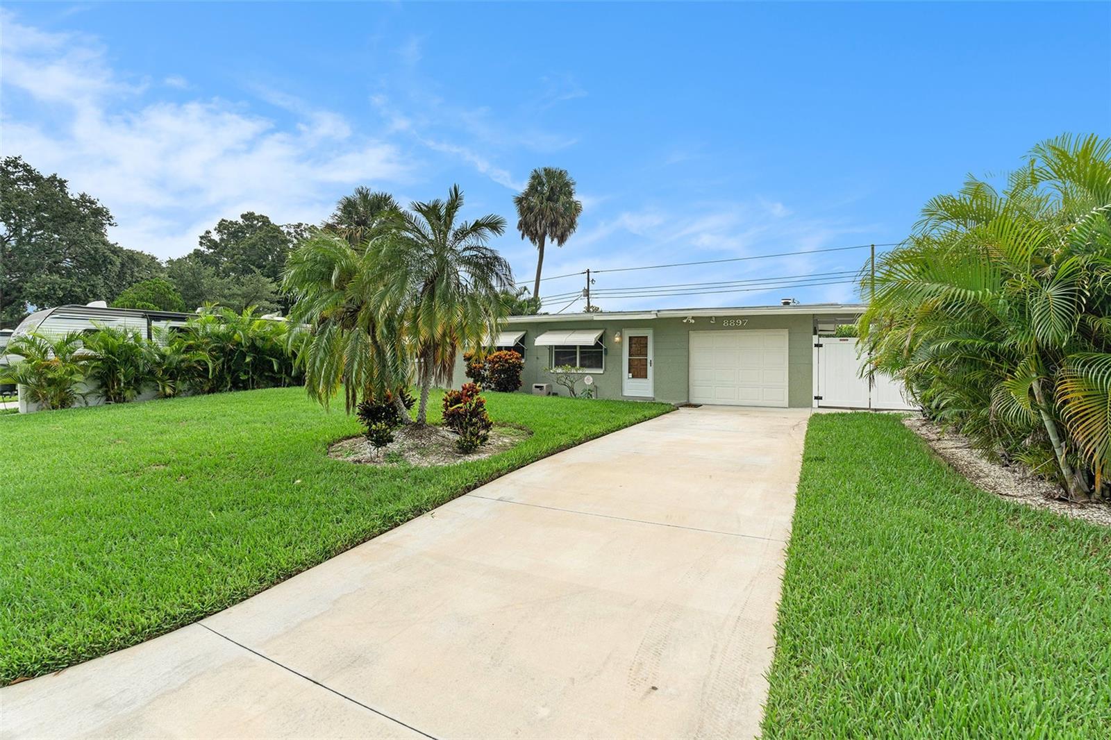 Welcome Home to this inviting 3-bedroom, 1-bath home nestled in Cross Bayou Estates. Ideal for entertaining, this residence features a spacious 15 x 16 enclosed porch with fireplace(not included in the square footage) and a spacious 15 x 24 covered, screened porch overlooking a serene, tropical yard with an in-ground pool and a large detached storage shed. The kitchen boasts beautiful granite countertops and newer appliances. The bath has experienced recent updates with a newer shower surround, vanity and fixtures. Additional highlights include an attached one-car garage with loft storage, and a convenient carport, ideal for golf cart or motorcycle parking. The exterior boasts new sod, sprinkler system, and a new oversized driveway. This home is a rare find with no HOA and no rental restrictions, making it one of the few properties in the area fully open to short-term rentals and Airbnb hosting.(with proper STR certificate). Don't miss the opportunity to make this tropical retreat your new home! Call today for a private showing!