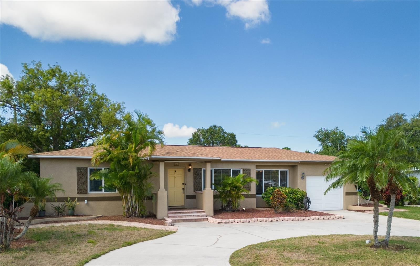 Key West Vibes in this Kenneth City LAKEFRONT Home!! Tropical Landscaping and the Interior Color Palette put you into the Vacation feeling every day! Enjoy this 4 Bedroom Home with 2,096 sf of Living Space and a NEW ROOF in 2023! Featuring Wood Floors in the Living / Dining / Kitchen and Bedrooms 2 and 3! Double Master Bedrooms possible here in a Split Floorplan. The main Master Bedroom has an En Suite Bathroom with a Step in Shower and large Soaking Tub! The 2nd Master Bedroom is large enough for a Home Office space and has access to the Sun Porch. The Kitchen has lots of cabinet space with a built in wine rack and glass accent feature. The counter area is accessible from the Living and Dining areas so entertaining is a breeze! Updated recessed lighting too! There is a large Family Room area in addition to the Sun Porch which has real windows for use all year long. Step outside to the brick pavered patio area where you can enjoy those Summer BBQ's. Imagine relaxing in this large fenced back yard overlooking pretty Lake Charles. For a closer look you can sit on your private dock! All this located within minutes of shopping, restaurants and those Beautiful Beaches, including John's Pass, etc. A wonderful local park, James P Ernst Park, is an easy 1/2 mile walk and it features a playground, splash pad, picnic area, tennis court, basketball and more! Don't miss this opportunity - call for your showing today!
