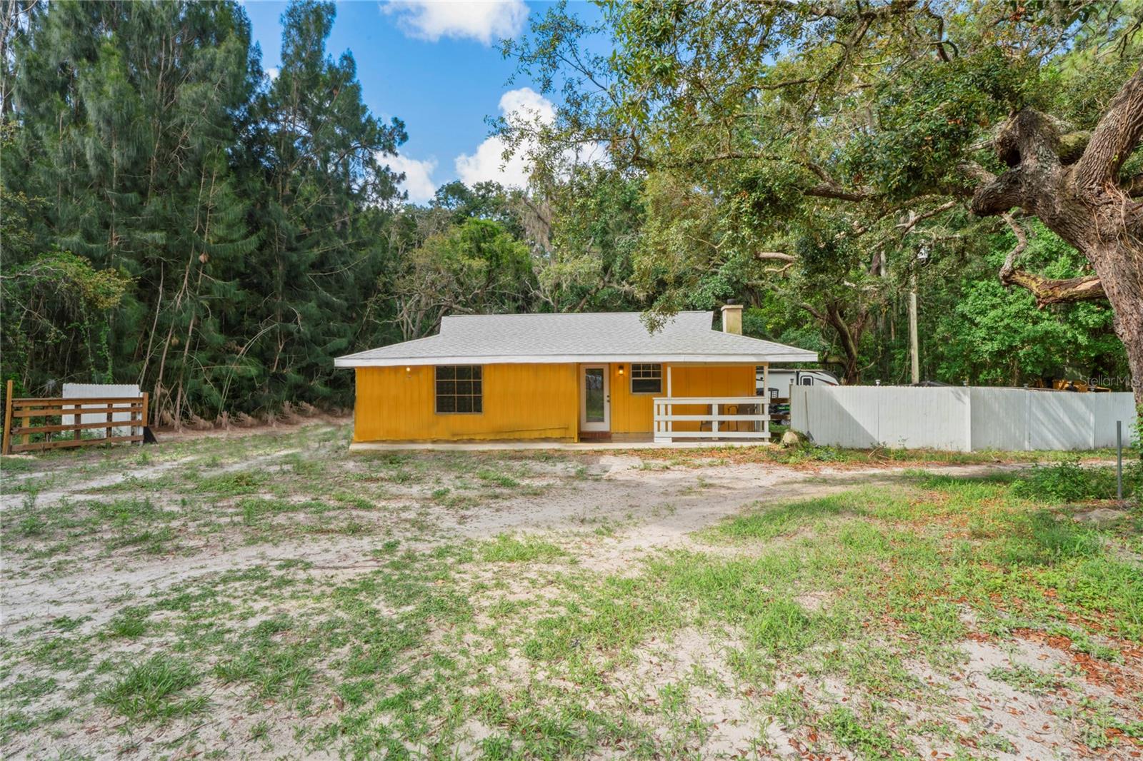 Charming Cabin on 5.68 Acres – A Hidden Gem in Port Richey! Step back in time with this cozy cabin, believed to be one of the original hunting retreats from the early 1970s—a rare piece of local history nestled on 5.68 fully fenced acres. With a new roof, partially cleared land, and plenty of space for all your toys, this property is bursting with potential. Enjoy country living in the heart of Port Richey, just minutes from everything yet peacefully secluded. The open front porch welcomes you in, and the wood-burning fireplace makes for a warm, rustic centerpiece inside. There’s also a convenient indoor laundry area and room to expand or build. Thinking of building your dream home? This is an ideal location. Use the existing cabin as a guest house, rental, family retreat, or even a future pool house. Opportunities like this are rare—not much land left in this area! Don’t miss your chance to own this diamond in the rough with a rich past and a promising future.
