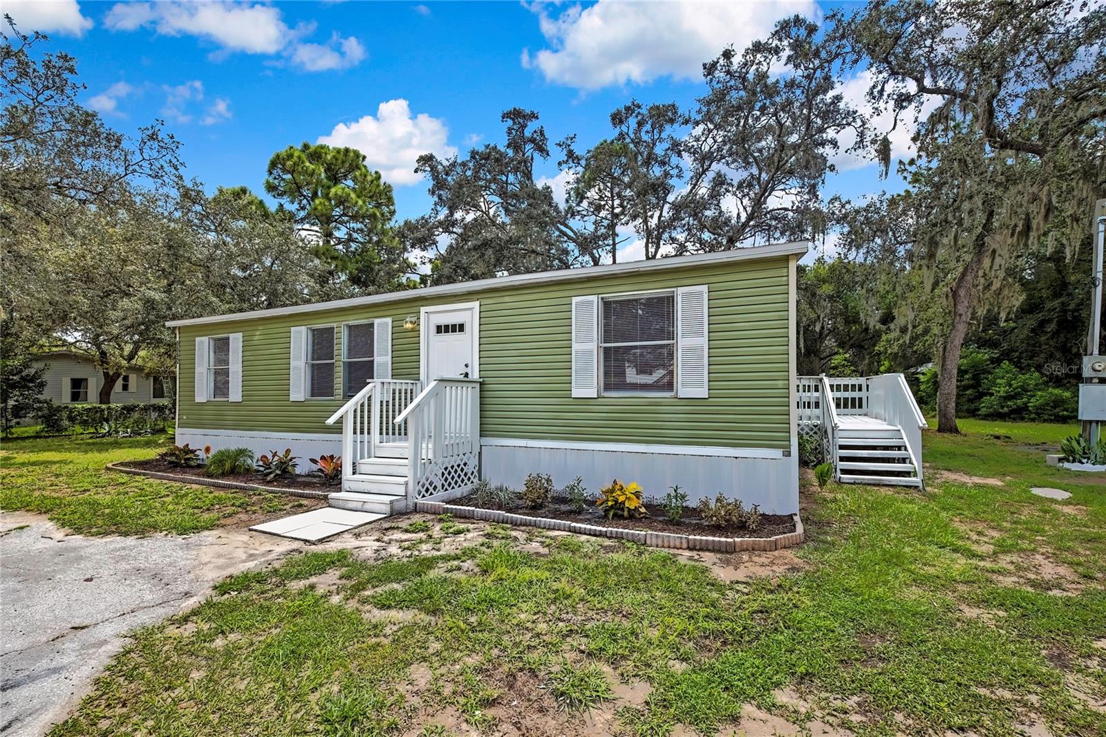 Welcome Home to this beautiful and completely updated manufactured home features 3 bedrooms, 2 full size bathrooms and sits on a boastful 0.51 acre lot. The inside features an open floor plan with a Living Room/Kitchen combo and is complete with a fresh coat of paint, updated drywall throughout, new cabinets, new counter tops, new vanities in both bathrooms, ceiling fans installed in all rooms, recessed lighting throughout, Luxury Vinyl flooring and more. The outside is fully fenced in and features a fresh coat of paint, New AC unit, and New Roof installed 2025. Call today to schedule your showing!