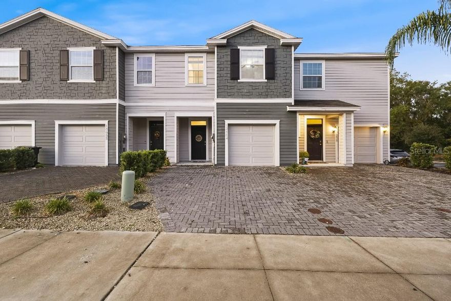 Experience refined living in this stunning townhome located in Newberry.  The open floorplan welcomes you with abundant natural light and stylish finishes throughout. The gourmet kitchen features granite countertops, stainless steel appliances, and a spacious island perfect for gathering with family or friends.

Enjoy seamless indoor-outdoor living with sliding doors that open to a private screened lanai overlooking peaceful green space, a perfect spot to unwind or entertain. Upstairs, the primary suite offers dual walk-in closets and a spa-inspired bathroom with double vanities and a walk-in shower. Two additional bedrooms share a beautifully designed full bath, and the laundry area is conveniently located on the same level.

Additional highlights include tile flooring throughout the main living area, a one-car garage, and professionally maintained landscaping. Perfectly situated near shopping, dining, and major routes, this home offers an ideal blend of comfort, style, and convenience. Welcome home.