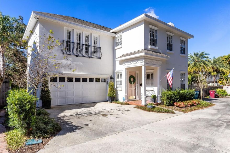 Tucked away on a private drive just off College Park’s charming brick-lined streets, this thoughtfully updated two-story residence in the Porches of Atkins Place offers privacy, character, and extensive recent improvements totaling over $60,000. The home blends timeless architectural details with meaningful upgrades that enhance both everyday comfort and long-term value.

The main level features fully refinished hardwood floors and wood staircase, crown molding and plantation shutters throughout, allowing natural light to fill the living spaces. The living room is positioned at the front of the home and is anchored by a wood-burning fireplace, creating a warm and inviting setting. Toward the rear, the dining area connects directly to the backyard through French doors, offering an ideal layout for entertaining while maintaining defined living spaces. The kitchen has been tastefully updated with granite countertops, stainless steel appliances, glass-front cabinetry, generous cabinet storage, and breakfast bar seating. A large wraparound storage closet beneath the staircase provides exceptional hidden storage rarely found in homes of this size.

Outdoor living is a true highlight, with a professionally redesigned courtyard-style garden featuring updated irrigation, brick paver walkways, mature landscaping, and fruit-bearing lemon and lime trees. An electric canopy with integrated lighting provides flexible shade and creates a comfortable outdoor setting for dining or relaxing year-round.

Upstairs, a versatile loft and landing area with built-in desk and shelving offers an ideal home office or creative space. The primary suite is spacious and includes French doors opening to a private balcony, a walk-in closet, and a well-appointed en-suite bath with dual sinks, a soaking tub, separate shower, and pocket door for added privacy. One secondary bedroom offers direct access to the full bath through a pocket door, providing additional privacy for guests or family members. The laundry room is conveniently located on the second floor and includes the washer, dryer, extensive cabinetry, a utility sink, and a linen closet for added organization.

Recent improvements completed within the past two years reflect significant pride of ownership and include a new roof in 2023, full interior and exterior repaint, hardwood floor refinishing throughout the entire first floor and stairway, updated lighting and hardware throughout, extensive landscape and irrigation upgrades, an electric outdoor canopy with lighting, enhanced home security system with exterior cameras, updated kitchen appliances, and refreshed bathroom mirrors. The home is also protected by an active termite bond.

Additional practical features include an attached two-car garage and generator readiness with a whole-house connection point located at the rear of the home.

Set in one of College Park’s most established and walkable areas, just minutes from Edgewater Drive, Lake Adair, Downtown Orlando, Winter Park, major hospitals, and easy access to I-4 and the 408, this home offers a rare opportunity to enjoy a quiet, private setting with substantial recent upgrades.