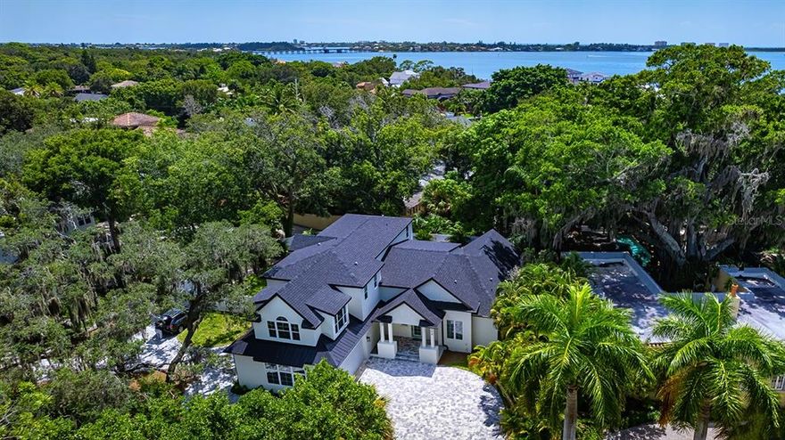 New West of the Trail, in MCCLELLAN PARK custom-built, coastal contemporary pool residence featuring 5 bedrooms, 4.5 baths plus in home elevator built by Trend Building and Development Inc. completed June 2022.

Designed finishes include an astonishing spacious Great Room with volume ceilings, wood flooring open kitchen with custom cabinetry, generous Quartz countertops and Island, Viking stainless steel appliances with a natural gas cooktop and two ovens.

 Primary Master Bedroom en-suite located on the first level with custom finished walk-in closet and sliding glass doors with views of the pool and backyard. Master's en-suite bath includes freestanding soaking tub, glass-enclosed shower with a rainfall showerhead, and solid wood cabinets including dual sinks and Quartz countertops.

Private fenced and gated back yard with gas-heated pool that showcases pavers and pebble tec finish, an outdoor kitchen for entertaining, covered lanai areas, plus a bonus off pool entertainment room with wet bar.

2nd floor living level offers ideal family or guest retreat with multiple baths, bedrooms and bonus room accessed by custom stairwell or in home elevator.

Warp around paver drive way allows access and sense of arrival to the property form both McClellan Parkway and Wewa Dr along with additional parking for guests and home owner.

Ideally located in highly-sought after McClellan Park and close to Southside Elementary, Southside Village, Downtown Sarasota, Sarasota Memorial Hospital, Marina Jack and Bayfront Park, Siesta Key, Lido Beach and St. Armand’s Circle.