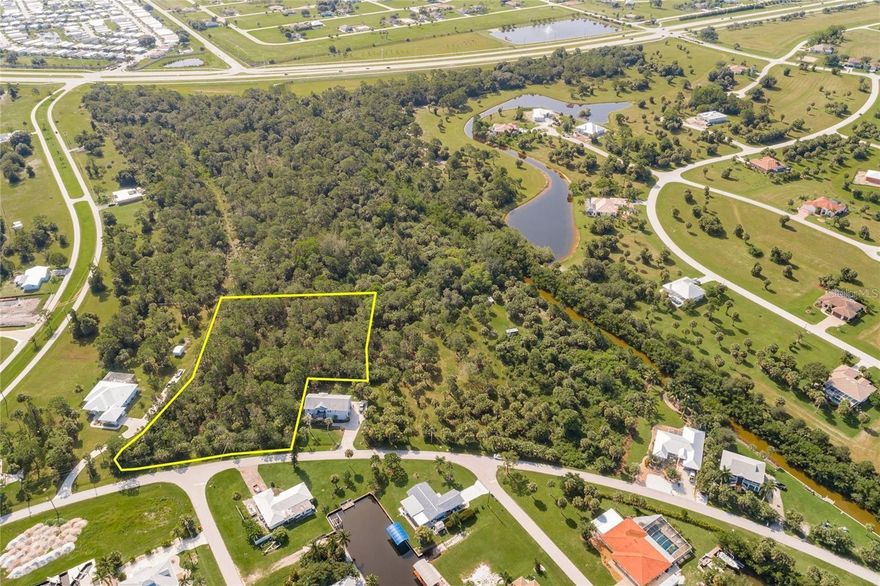 Discover the ideal setting for your custom home on this 2.07-acre property in Pirate Harbor. With optional HOA membership and public utilities available, this lot offers both flexibility and convenience in a peaceful coastal environment—perfect for those seeking privacy, space, and a connection to nature. Located in a true boating and fishing paradise, you’ll be just minutes from an extensive network of waterways and public access points, making it easy to enjoy Southwest Florida’s outdoor lifestyle. From kayaking serene canals and birdwatching in the surrounding natural habitat to world-class fishing, the opportunities for recreation and relaxation are endless. Conveniently positioned just off US-41 (Tamiami Trail) in the desirable Burnt Store Lakes/Pirate Harbor area, the property combines a tranquil, nature-focused setting with excellent access to everyday amenities. To the south, Burnt Store Marina offers waterfront dining, golf, boating, and social activities, along with quick connections to Cape Coral and Fort Myers for expanded shopping, dining, and entertainment. To the north, downtown Punta Gorda, Port Charlotte, and North Port provide additional conveniences, including Harborwalk, Fishermen’s Village, medical facilities, parks, shopping centers, and a wide array of restaurants and services along the US-41 corridor. Residents may also enjoy access to Burnt Store Lakes community amenities such as a park, picnic areas, and a kayak/canoe launch with entry to Charlotte Harbor. Grocery stores, schools, healthcare, and daily essentials are all within a short drive, offering an ideal balance of tranquility and accessibility. ALSO - An incredible opportunity awaits, as the neighboring lots located at 24511 Yacht Club Blvd and 24397 Jean La Fitte Blvd are also available for purchase. Combined, all three connected properties total approximately 6 acres, creating a rare chance to own an expansive waterfront estate with endless possibilities.