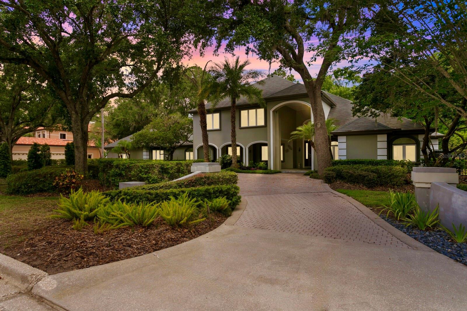 A Private Retreat with Premier Golf Course Views in One of Tampa’s Most Coveted Gated Communities.
Discover an extraordinary lifestyle in The Reserve, a prestigious 24-hour guard-gated enclave within Tampa Palms. Perfectly positioned along the 3rd hole of the Tampa Palms Golf Course, this estate offers sweeping fairway views and a serene backdrop of manicured greens that create a truly impressive setting.
From the moment you arrive, the grand semi-circular paver driveway makes a bold first impression, providing ample guest parking and a welcoming front porch finished in elegant marble tile. Step through the stately entryway into a soaring two story foyer where coffered ceilings, a dramatic great room, and a richly appointed executive office set the tone for timeless design and functionality. The main home features five spacious bedrooms and five full bathrooms, thoughtfully designed to accommodate both everyday living and large-scale entertaining. An attached guest house enhances the property’s versatility, complete with its own private kitchen featuring a gas range, a full bathroom, and a separate entrance. It’s ideal for extended stays, multi-generational living, or a private workspace.
The gourmet kitchen includes granite countertops, extensive cabinetry with pull-out shelving, stainless steel KitchenAid appliances, and a casual dining nook that overlooks the outdoor living space. The inviting living room showcases striking open beam ceilings and a cozy gas fireplace, complemented by a built-in wine bar and bookshelves, setting the stage for effortless entertaining and warm gatherings.
The oversized primary suite is a true retreat, complete with a private reading area, wet bar, custom wood molding and elegant coffered ceilings. It features two walk-in closets with built-ins and a luxurious en suite bathroom with dual vanities, a large walk-in shower, and a deep soaking jetted tub, perfect for unwinding in.
Upstairs, a loft-style seating area connects to three additional bedrooms and two bathrooms, offering flexibility for guests, family, or creative use.
Outside, your private resort awaits. The lagoon-style pool and spa feature a sun shelf with an umbrella holder and stone fountain, vibrant LED lighting for evening ambiance, and a dramatic stacked stone waterfall that cascades into the heated spa. Fire bowl accents and flagstone pavers complete the setting, all designed for relaxation and direct access to the golf course.
This home also carries a unique legacy, having once been owned by 14-time Grand Slam tennis champion Pete Sampras, offering not only luxury but also a touch of sporting history.
Conveniently located near I-75, USF, Moffitt Cancer Center, the VA Hospital, and just a short drive to Tampa International Airport, shopping, dining, and entertainment, this rare offering combines elegance, privacy, and an unbeatable location.