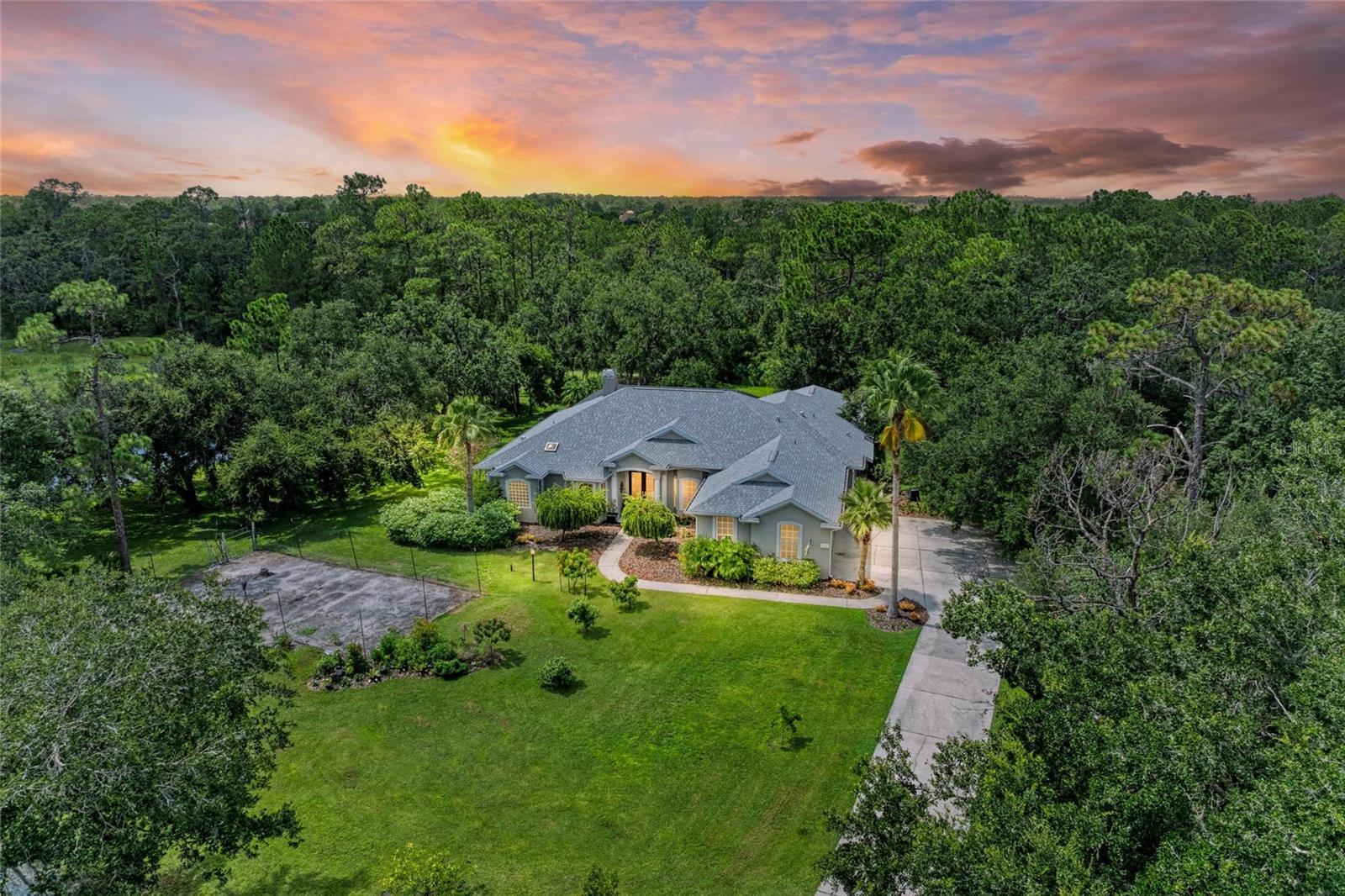 This stunning private oasis offers four bedrooms, three bathrooms, an office, a den, all nestled beside a serene preserve and tranquil lake. Step through eight-foot designer glass doors into a fully updated interior that radiates elegance and quality craftsmanship. The dining and living areas are filled with natural light and highlighted by a beautiful gas fireplace, crown molding, 12-foot ceilings. Pass through to the tray-ceilinged gathering room with theater-quality sound system and expansive walls, sliding doors to the lanai, and a Wi-Fi sound system wafts throughout the home. The chef's kitchen is an entertainer’s dream, featuring a dedicated baking station with its own dedicated cabinetry, including a pop-up mixer. A beverage station, 10’ quartz island with double sided cabinets beneath, double ovens (one is convection!), 36" six-burner gas range top and professional hood, with a pot filler fitted into an Italian tile backsplash. There’s a large 3 level spice drawer, and custom pull-out drawers in all lower cabinetry. The breakfast area boasts an aquarium-style window that frames the natural beauty of the outdoors. The spacious primary suite with double walk-in closets and sliding glass doors opening to the lanai. Wait, we have to tell you about the luxurious, primary BATH! Premium tempered glass ushers you in to the contrasting no entry floor, and waterfall shower wall with double niche! A 36x18 floating bench, another handheld shower, and another niche makes an additional showering area. All GROHE fixtures, a stand-alone soaking tub, double SEPARATE vanities, no-fog lighted mirrors.
A beautifully renovated “Mother-in-law suite” on the other wing of the house provides privacy and comfort with its own entrance, bedroom, den, and renovated bath. Two additional bedrooms have window seats with storage that share a stylish separated Jack and Jill bathroom.
Outside, enjoy a large, heated, saltwater pool and spa surrounded by lush nature, preserve views, and lakefront serenity. The front of the property features fruit trees and a rich- soiled vegetable garden, but this can be removed and sodded if the buyer requests. Tucked in a treed area beside the backyard is a storage/workshop building with a partial second floor.
This home blends luxury, privacy, and thoughtful design for an unmatched living experience.
*Complete remodel pool bath 2025
*New roof 2024
*Replace front doors with double 8’ fiberglass Therma Tru Artisan doors 2024
*PennAire Salt Cell and Wi Fi controller 2024
*Pool cage with SS Screws & 20-20 Mesh 2024
*Replaced AC 2023
*Complete remodel of Primary Bathroom 2023 - Remotely controlled solar accordian blinds in Primary Bath and Gathering Room
*Replaced Well pump, whole house water treatment system 2021
* Complete Kitchen & Gathering Room remodel with new SS appliances and premium cabinetry 2021
* Fruit Trees- 4 dwarf mango, 3 Sugar Bell, a Meyer Lemon, a Loquat 2022-24