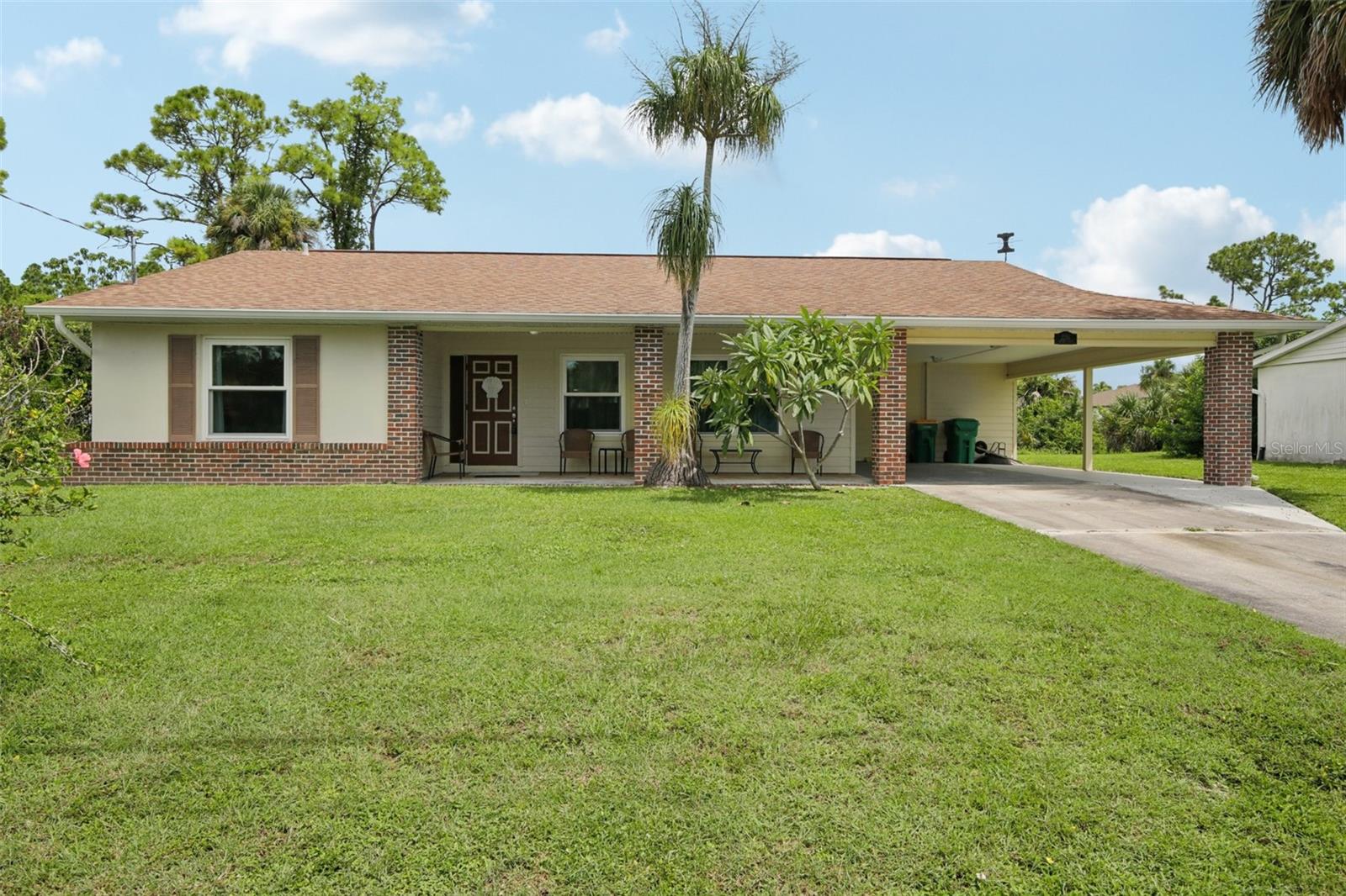 No Flood Zone! Discover this spacious and expanded two-bedroom saltwater-front home, perfectly situated in the heart of paradise. A welcoming front porch sets the tone as you step inside to a large living room, followed by a dining area that flows seamlessly into a recently remodeled kitchen featuring granite countertops, updated cabinets, and beautifully upgraded bathrooms. Beyond the dining space, you’ll find an enclosed, air-conditioned Florida room with walls of windows, offering the perfect spot to relax year-round. This home is packed with extras: a generous laundry room with ample storage, plus a separate shop/storage area with stainless steel shelving. Since purchasing, the owners have nearly doubled the size of the two-car carport, installed a 6,000-lb boat lift, extended the dock with water and electric, added new impact windows (2018), and installed a new heat pump in 2024. Boating enthusiasts will love the easy access—just a 20-minute ride to Charlotte Harbor and beyond to open waters. The location is equally convenient by land, with shopping, healthcare, Charlotte Sports Park (spring training home of the Rays), and sandy Gulf beaches all just minutes away. And importantly: no flooding or storm damage from the last two hurricanes. Don’t let the two-bedroom count fool you—this home lives large and offers all the space you need. Schedule your showing today and start enjoying the easy Florida lifestyle.