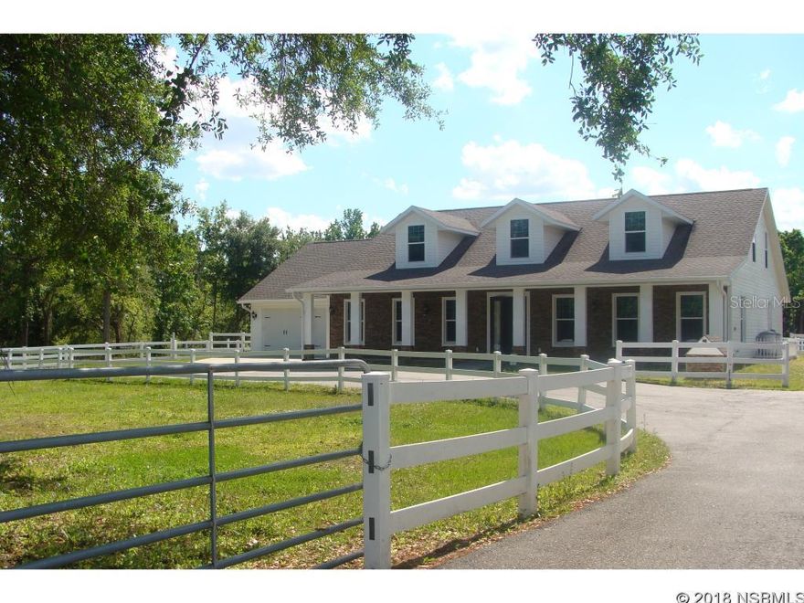 SPRUCE CREEK FARMS CUSTOM ESTATE HOME LOCATED ON A PRIVATE STREET WITH OVER 3 ACRES! Five stall barn, ranch style fencing, private small pond, oversized driveway and plenty of room for all your recreational vehicles! No HOA, bring your boat and RV! The floor plan features 5 bedrooms with 4 baths, a huge bonus room up with a wet bar! The 2 additional bedrooms up do not have closets. The master bedroom and bath are located on the main floor with an additional two bedrooms and two baths. The second bonus up can be counted as a 6th bedroom! There is also an office off the kitchen with a built-in desk and Murphy bed. The Dream gourmet kitchen has all top of the line SS appliances, a wine refrigerator, granite counter tops and custom wood cabinets! The five stall barn is equipped with feed and tack room and huge upper loft! Oversized 2 car garage and there is also an air conditioned workout room (13 x 10) off of the garage with its own outside entry. Conveniently located to major roadways, Daytona Beach and New Smyrna Beach! This property may be under audio/visual surveillance.