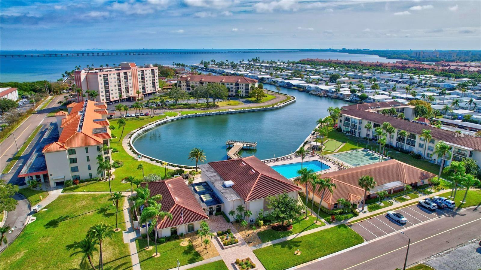 This active over 55 community will keep you young at heart. This condo is situated in the best location in The Cove. You will enjoy the view of the Cove, plus the pool, shuffleboard, putting green and all of the amenities of the clubhouse. You notice the gorgeous hardwood floors as you enter, and then the updated, elegant kitchen to the right. But the VIEW as you enter the living area is spectacular with the full windows giving so much radiance. Each bedroom has been updated. A full ballroom for dinners, dances and entertainment. There is a billiard room and two workout rooms with saunas. Also, two game rooms and a library with a covered patio by the pool with grilling for everyone. The Cove flows out to the Bay which surrounds the community. You will want to bring your fishing gear.