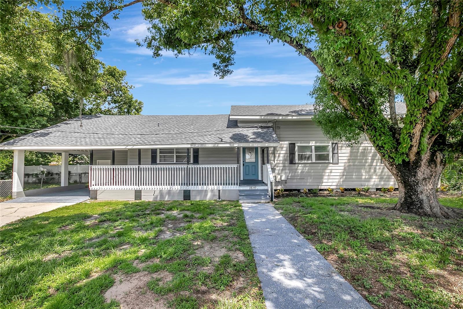 This 4 bedroom, 2 bath, DREAM HOME!!!! Massive wrap around porch, double carport and oversized lot with a side yard perfect for pets or children! This is one of the prettiest homes in Zephyrhills. Tastefully remodeled, with a new roof and AC in 2024! New paint and countless upgrades throughout. The first floor features lovely hardwood floors in a formal living room, formal dining room, and a first floor master suite. Additional 2 bedrooms and full bath downstairs. The gourmet kitchen includes granite countertops, stainless appliances and opens into the family room. Master bedroom is spacious with lovely decorative touches, walk in closet and grand master bath. Upstairs has a large game room and additional spacious bedroom with all new flooring and paint. Call today for an appointment to see and enjoy this beautiful home for yourself.