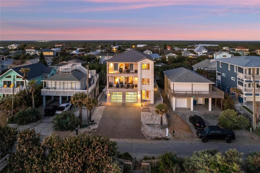 Welcome to this luxurious 3-story executive pool home, a serene beachfront haven nestled in the Bethune Beach area of New Smyrna Beach, FL. This exquisite property boasts breathtaking views of the ocean from every floor, accentuated by its coveted location on a no-drive beach. Upon entering, you're greeted by a visually stunning cherrywood staircase that sets the tone for the elegance that unfolds throughout. Each spacious room across all 3 floors features soaring 12-ft high ceilings, creating an airy and opulent atmosphere. The 2nd floor is the heart of the home, featuring a primary oceanfront living room leading to the large chef inspired kitchen. Well equipped for the ultimate culinary experience, the kitchen is a masterpiece, outfitted with top-of-the-line Viking appliances, a 6 burner gas range, 3 ovens, 2 dishwashers, a large side-by-side refrigerator/freezer, new wine cooler, and a Miele coffee/espresso machine. The bar area, with ample cabinets and storage space, is perfect for entertaining. Adjacent to this is a large formal dining area, overlooking the pool, complete with a balcony and outdoor grill. This is the perfect place to watch the stunning sunsets over the river only a stone's throw away. For convenience, this luxurious home includes a 6-person elevator serving all floors. Flooring is an elegant mix of Brazilian cherrywood and Travertine tile, complemented by granite countertops. The first floor houses a secondary kitchen, living room, laundry room, and a large in-law or family room area with a separate entrance, offering ample space for additional friends or family to enjoy. On the 3rd floor you’ll find the master suite featuring a gas fireplace, large balcony with panoramic Atlantic views, and an en-suite bathroom w tub, shower, and dual vanity. Additionally you’ll love the custom, his & hers walk-in closets with beautiful custom cabinetry and tons of space. An adjoining office area and morning kitchen add to the suite's exclusivity. Notable features include 2 massive balconies w ocean views, a 2-car garage with glass doors for an ocean view, 2 additional guest bedrooms w en suite on the 3rd floor, and a separate laundry room on the 3rd floor. Additionally, all 3 HVAC units have been replaced and upgraded, along with a tankless gas hot water heater, ensuring optimal comfort and energy efficiency. Plantation shutters on all windows, a surround sound throughout the house, and a security system with cameras, all contribute to the home's luxurious appeal. At the rear of this stunning home you’ll find a solar-heated pool w a wrap-around patio, outdoor shower, and winding staircase for access from the 2nd floor. The home's construction is a testament to durability and quality, with 3-stories of steel and poured concrete combined with a metal roof. The Coquina exterior stucco finish, accentuated by contrasting railings, adds a touch of elegance. Freshly painted from head to toe, this home has been well cared for, and well maintained. Experience a tranquil, exclusive beachfront oasis with a no-drive, private stretch of sand, personal sun deck, and direct beach access. Located in New Smyrna Beach, FL, known for wide sandy beaches, perfect for water sports and beach lovers. The vibrant town boasts art festivals, galleries, and a historic downtown with events. The warm climate appeals to those looking for fun year round. Welcome home to luxury, comfort, and tranquility, a rare gem on the Atlantic, ready for exceptional living.