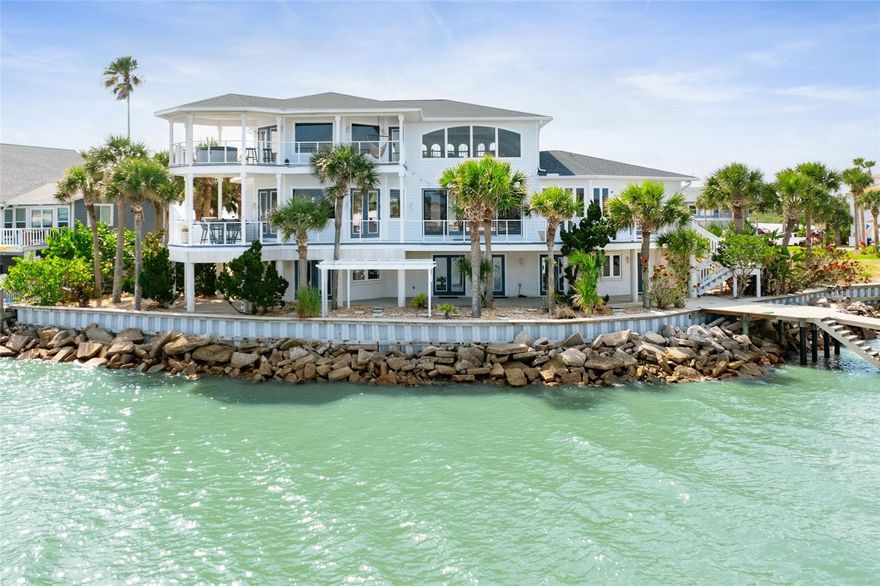 A place like no other! Step into a world of unparalleled serenity and opulent living with this exquisite waterfront estate, ideally positioned where the Matanzas inlet, the Atlantic Ocean, and the Intracoastal Waterway converge. Every day feels like a vacation at a five-star resort with this stunning property, meticulous custom design to capture every moment of natural beauty. Enjoy breathtaking views that sweep across the merging waters, perfect for boating, fishing, and a day at your private beach. Designed for those who demand the best in life, indulge in the luxury of your own private retreat where elegance meets tranquility—your dream home awaits, enveloping you in a panorama of beauty and peace. Featuring 4,538SF with 5 bedrooms, 3.5 bathrooms plus over 2,000SF of exterior porches/decks, soaring ceilings, expansive living and dining areas all with picturesque water views! From the coastal etched double glass entry door your eyes are drawn to the water through the wall of windows and glass doors lead you to 1 of 4 expansive decks where you will find yourself spending all your time! On the main level, the kitchen is a chef’s delight with a double oven, gas range, built-in microwave, and easy loading elevated dishwasher. A breakfast bar with seating extends into the family room for your extra guests and an extra bank of cabinets with a wine cooler. The dining room is set apart and complimented by a one of a kind oyster shell chandelier illuminating the table. Right off the kitchen, enjoy sunset dining on the covered deck with a convenient built-in grill and green egg. On the other end of the home is a half bath for guests and a guest bedroom with en-suite bath and doors to the deck. Head up the stairs to the master suite where your first stop will be the landing with panoramic water views. This may become one of your favorite spots to drink your morning coffee or read a good book. The master bedroom features a tray ceiling and yet more picturesque views from your bed. Double doors lead to your own private oasis with a hot tub to soak in while star gazing at the end of your day. The master bath is its own sanctuary with a jetted soaking tub, walk in shower, dual vanities and large closet. An additional bedroom that can be used as an office is just off the master bathroom with a private deck. On the lower level of the home is the perfect spot for all of your guests with 2 additional guest bedrooms and a shared european style bathroom with access to the outdoors. An oversized flex room can be used as a gym, an additional family room, or a hobby space. The possibilities are endless with this space. Each floor of this multi-level home boasts outdoor decks, offering sweeping views that capture the natural beauty of the surrounding landscapes. For boating enthusiasts, the property is a paradise including a private boat dock and lift, making it easy to set off for a day on the water or enjoy spontaneous nautical adventures off shore. At low tide, you have the ideal private beach to wade in and let the kids play or launch the kayaks and paddle boards. Across the waterway is a preserved beach so your views will never change. The oversized 2 car garage offers plenty of extra storage space, a door to the dock and outdoor shower as you come in from a day on the water.  Whether entertaining guests or seeking a peaceful retreat, this home is a true sanctuary where every element has been crafted for an exceptional living experience. Welcome home!