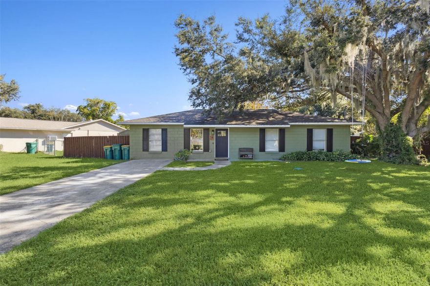 Welcome home to this move-in ready waterfront retreat tucked away on a quiet cul-de-sac, where nature, comfort, and convenience come together. This charming single-story home sits gracefully beneath mature oaks on a large lot backing to a peaceful private pond, offering both privacy and everyday connection to the outdoors. Step inside and you’re welcomed by a spacious living room with vaulted ceilings, wood-look tile flooring, and abundant natural light. The open flow makes this space perfect for entertaining or relaxing, with sliding glass doors that draw your eyes toward the shaded patio and water views beyond. Directly off the main living space, a generous flex room under full A/C offers endless versatility—currently used as a bedroom, it also works beautifully as a home office, playroom, or gym to fit your lifestyle. On the right side of the home, three true bedrooms form a private wing. The primary bedroom serves as a comfortable retreat with its own ensuite bath, while two additional bedrooms share a conveniently located full bathroom, ensuring both function and privacy for family and guests. The reimagined kitchen is another highlight, blending function and character with painted cabinetry, modern hardware, a statement hood, floating shelving, and marble-look counters. Open to both the dining space and living area, it allows the cook to stay connected during meals or gatherings, making the home feel both open and practical. A dedicated laundry and utility room adds convenience and storage. Cosmetic upgrades throughout include fresh interior and exterior paint, newer flooring, updated fixtures, and matte black accents that bring a modern edge. Just as important, the home’s major systems have been thoughtfully updated: the roof was replaced in 2017, and the HVAC system was installed in 2019 and remains under regular service. With these updates complete, buyers can enjoy peace of mind and efficiency for years to come. Outdoors, the property shines with a deep covered patio that extends the living space, perfect for grilling, lounging, or outdoor dining. The fenced backyard is a true highlight, offering privacy, mature trees for shade, a large fire pit gathering area designed for memorable evenings with family and friends under the stars, and an outdoor storage shed that conveys with the home for tools, lawn equipment, or hobbies. Beyond the fence, tranquil pond views create a daily backdrop for birdwatching, fishing, or simply unwinding. The lot’s position on the curve of the street not only reduces through traffic but also provides a larger yard than many nearby homes. The location balances quiet retreat with convenience—just minutes from Lake Eustis and the Harris Chain of Lakes for boating and recreation, as well as the vibrant downtowns of Eustis, Mount Dora, and Tavares for dining, shopping, and community festivals. With its updated systems, stylish upgrades, versatile layout including a true A/C-cooled flex space, and a backyard designed for Florida living, this home delivers pond-view serenity, modern comfort, and Central Florida’s lakefront lifestyle all in one.