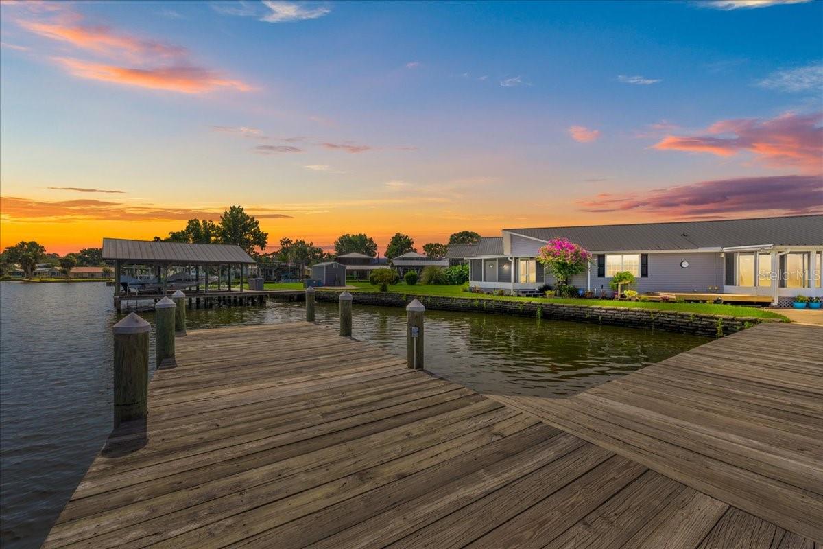 Welcome to riverfront living in the heart of Sportsman's Harbor, located in charming Welaka, FL! This 3-bedroom, 2-bath home offers 1,968 sq ft of comfortable, updated living space and 118' on the St. Johns River. With durable vinyl siding and a long-lasting metal roof, for a low maintenance home so you can enjoy your days on the river. A private dock, boat house with two boat lifts, and shared T-dock provide everything you need for your boating lifestyle. There's also a handy storage shed and a 2-car carport for added convenience. Step inside to find luxury vinyl plank flooring throughout, a modern kitchen with sleek granite countertops, and a neutral, cohesive paint palette that gives the home a calm and inviting feel. Enjoy the practicality of a separate laundry area and unwind at the end of the day one of the two screened-in back porches as you take in peaceful views of the river. Whether you're an avid angler, weekend boater, or simply want to soak in the serenity, this home offers the perfect blend of comfort and community. Come live among fellow water lovers and experience the unique lifestyle only the St. Johns River can provide!