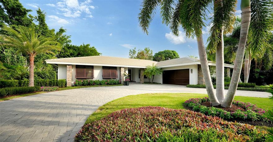 Experience a stunning transformation in this meticulously updated garden home nestled in the prestigious Bird Key community. Every inch of this captivating three-bedroom, three-bathroom residence has been thoughtfully renovated, promising a lifestyle of contemporary comfort. From the newer roof to the modernized interiors, this home offers a fresh start and awaits your personal touch. Immaculate landscaping, featuring lush greenery and meticulous attention to detail, sets the stage for the elegance that awaits inside. The pavered driveway and grand entryway provide an inviting welcome, setting the tone for the lavish experience that this home offers. Upon entering, solid wood and glass double doors usher you into the open living and dining room that beckons with its cathedral ceiling, glistening marble flooring, and a dual-sided gas fireplace. Each carefully crafted interior detail reveals itself, reinforcing the sense of opulence that defines this home. The contemporary eat-in kitchen is a masterpiece of modern design. Here, stainless steel appliances and fixtures, custom cabinetry, and sleek Caesarstone countertops combine to create a chic and functional space. This kitchen is more than just a place to prepare meals; it's an inviting haven where family and friends can gather, effortlessly flowing into the family room. Glass sliders in the family room lead to the beautifully updated pool deck, blurring the lines between indoors and outdoors. Whether you're enjoying a leisurely morning coffee or a private evening by the pool, the lanai offers the perfect backdrop. With newer pavered sundeck, an updated pool cage, privacy wall of Areca palms, and a resurfaced heated swimming pool, this space is an oasis of tranquility. The primary suite is a generous sanctuary, thoughtfully designed with your comfort in mind. Revel in the customized closets ensuring ample storage space, while the en-suite bathroom is a haven of luxury, boasting modern finishes that transform your daily routine into a spa-like experience. Guest bedrooms and the guest bathrooms have also undergone extensive updates. One of these bedrooms is currently utilized as an office. This exceptional garden home in Bird Key, with its extensive updates and prime location, is a rare opportunity to enjoy the very best that Sarasota has to offer. Living in Bird Key means embracing a life of elegance and convenience. This exclusive enclave is perfectly positioned between the vibrant downtown Sarasota and the charming allure of St. Armands Circle. A short stroll from your front door, you'll discover the delightful Bird Key Park. Consider joining the Bird Key Yacht Club to elevate your living experience even further, it's just moments away from your doorstep.