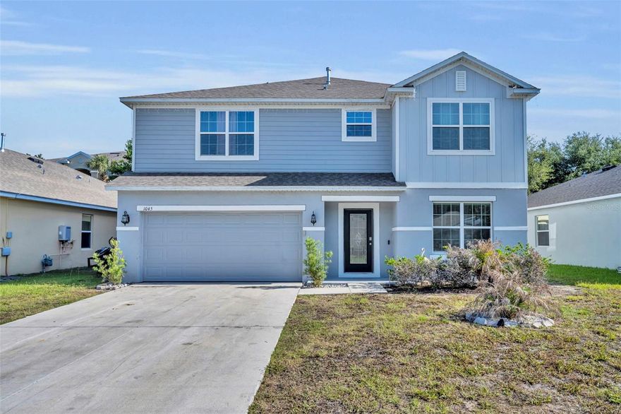 Welcome to this stunning 2024-built residence offering over 3,000 square feet of thoughtfully designed living space with 5 spacious bedrooms and 3.5 bathrooms. Showcasing more than $45,000 in upgrades, this home perfectly blends modern elegance with everyday comfort. Step inside to an open foyer with soaring ceilings and a dramatic upgraded staircase that creates an impressive first impression. Designer tile flooring, crown molding, oversized baseboards, and a light, neutral color palette flow throughout the home, complementing any style of décor. The gourmet eat-in kitchen is the heart of the home, featuring beautiful wood cabinetry, sleek granite countertops, stainless steel appliances, and an open-concept layout ideal for entertaining. Upstairs, the expanded bonus room provides flexible living space perfect for a media room, playroom, or home office. The luxurious primary suite offers vaulted ceilings, dual vanities, a spacious walk-in closet, and a private water closet for added comfort and privacy. Enjoy Florida living year-round on the screened lanai complete with ceiling fans, overlooking a backyard paradise designed for entertaining. The outdoor space features a bar area, pool table setup, lighting, and grill area, with plenty of room remaining to add a future pool. Additional highlights include a full 2-car garage and thoughtfully upgraded finishes throughout. Schedule your showing today!