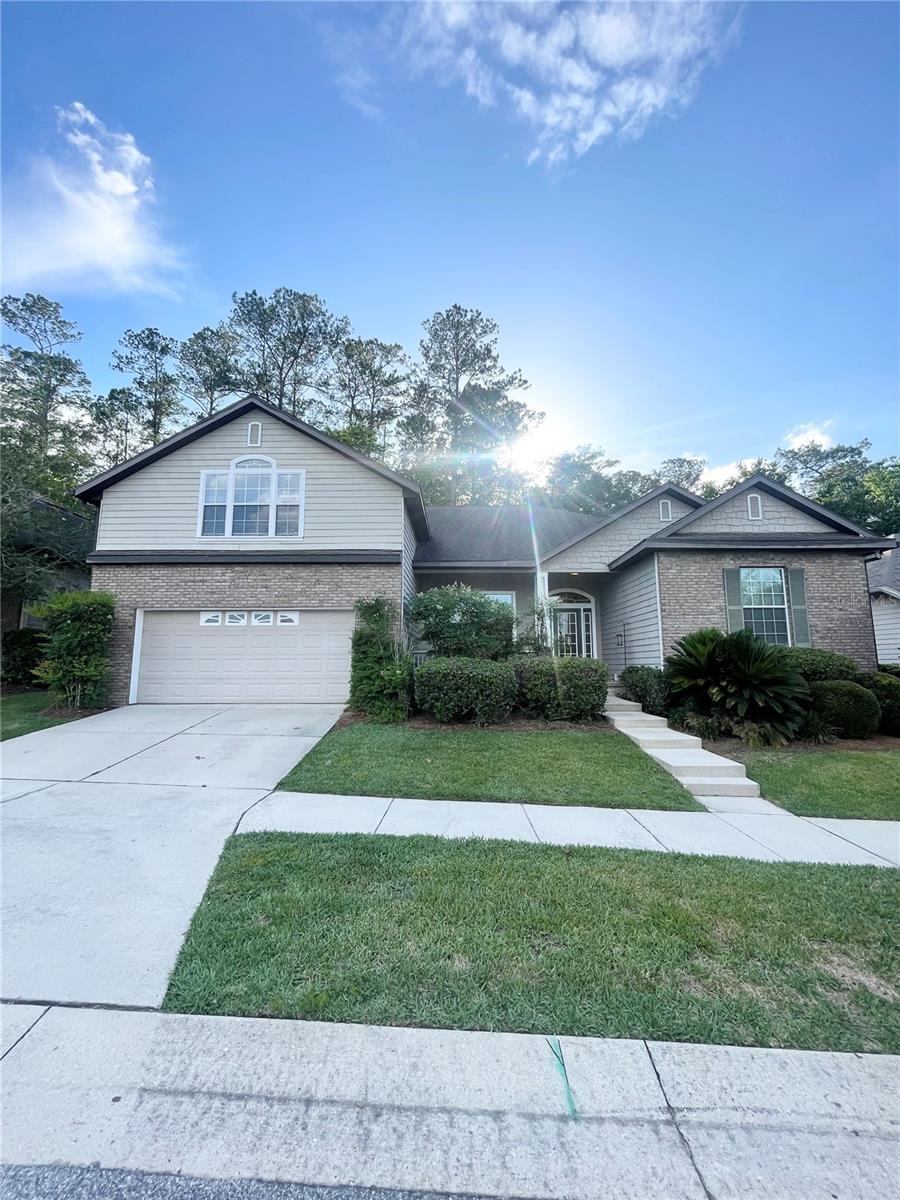 ATTENTION RENTERS!!! Welcome to the epitome of contemporary living in the highly sought after neighborhood of Ellis Park in NW Gainesville. This remarkable 2-Story, 4-Bedroom home w/Bonus room and 3.5 Bathrooms offers 2,875 square feet of pure luxury. From the moment you arrive, this residence captivates with its inviting front porch, exceptional curb appeal, and well-manicured landscaping.Inside, the interior showcases modernity and elegance with Vinyl plank flooring that graces every corner, while the kitchen and bathrooms feature tasteful tiled flooring. The Open floor plan with High ceilings creates an expansive and airy atmosphere, making it the ideal space for entertaining and everyday living. The Unique 3-way split floor plan with a 2024 HVAC under a soon to be 2025 Roof ensures ample space for all family members and guests. Upstairs Bonus Room can be used as an Office/den or a 5th Bedroom with door that closes. It has its own half bathroom and an enclave that could easily be sectioned off as a closet. A cozy Fireplace in the downstairs living room space becomes the heart of the home, complemented by crown molding that adds a touch of sophistication.The kitchen is a culinary delight with its New Stainless Steel appliances (2020)- including a Double oven, Oversized Kitchen Island, Stacked Stone Backsplash, and Expansive Granite kitchen countertops. The Honey/Chestnut cabinets provide an abundance of cabinet space, and storage. For gatherings and special occasions, the formal dining area is just steps away from the large foyer and the kitchen.The Primary suite is a sanctuary of relaxation, boasting a Jetted Garden tub, a Double sink vanity, and a Walk-in shower with a soothing rainfall shower head. It also offers the convenience of two large Walk-in closets and direct access to the outdoor screened patio.Step outside through French doors of either the Primary suite or the main living space to find your own exclusive paradise with a spacious, fenced backyard that backs up to a serene, forested lot. This charming outdoor space is graced with Meyer lemon, lime, orange, grapefruit, and tangerine trees. Savor the taste of fresh, homegrown citrus in your own backyard oasis. Outdoor living is a pleasure with both an outdoor patio and an elevated screened-in patio, offering endless possibilities for relaxation, entertainment and enjoying nature.Upgraded cabinetry in the laundry room space leads to where your vehicles will find a home in the 2-car garage equipped with an abundance of shelving and storage space.Neighborhood amenities include Well-maintained Sidewalks, aCommunity Pool and a Playground. Located within minutes to I-75 with easy access to UF/Shands, Santa Fe College, Celebration Pointe, Town Of Tioga and other renowned dining establishments and shopping areas that Gainesville encompasses. Don't miss the opportunity to make this exceptional property your new rental home. With its ideal location in NW Gainesville, this residence offers the perfect blend of tranquility and accessibility to all the amenities and attractions the area has to enjoy. ***Interior photos coming soon.