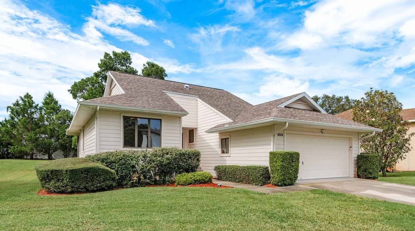 Welcome home to 1023 Lake Avoca Place, nestled in the coveted Pointe Alexis community where you can feel like you live in a resort every day. This three-bedroom, two-bathroom home with a two-car garage is beautifully updated. You will love the vaulted ceilings and all of the natural light in the living room. The kitchen has been updated to include granite countertops, modern cabinets and stainless-steel appliances. The primary bedroom is on one side of the home and connects to a beautiful, four-season sunroom. There is also a primary en-suite with dual vanities, tile shower and brand-new flooring. The primary walk-in closet has a built-in organizing system. The other two bedrooms are on the opposite side of the home, and they share an updated guest bathroom with a bathtub/shower combination. French doors from the living room lead to a covered, screened back porch. The backyard includes mature landscaping that provides privacy. At Pointe Alexis, the HOA manages your lawn care which gives you more time to enjoy the community pool, gym, clubhouse, tennis, pickleball and much more. The HOA fee includes the recreational amenities, grounds maintenance, water, sewer, trash removal, Internet and basic cable TV. Pointe Alexis is three and a half miles from the Sponge Docks and just two miles from Gulf beaches. Schedule your showing today to see this beautiful home and community.